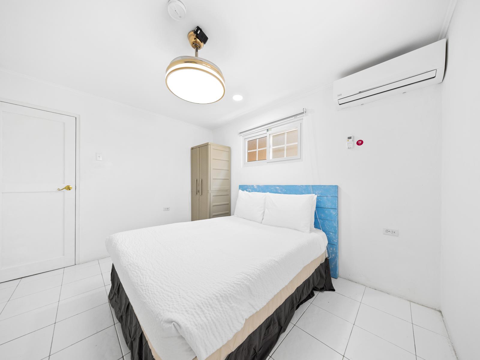 Bedroom is located on the first floor in the separate private apartment of the home in Noord Aruba - Plush double bed for restful night and efficient storage solutions - Minimalist decor, creating a clean and uncluttered sleeping space