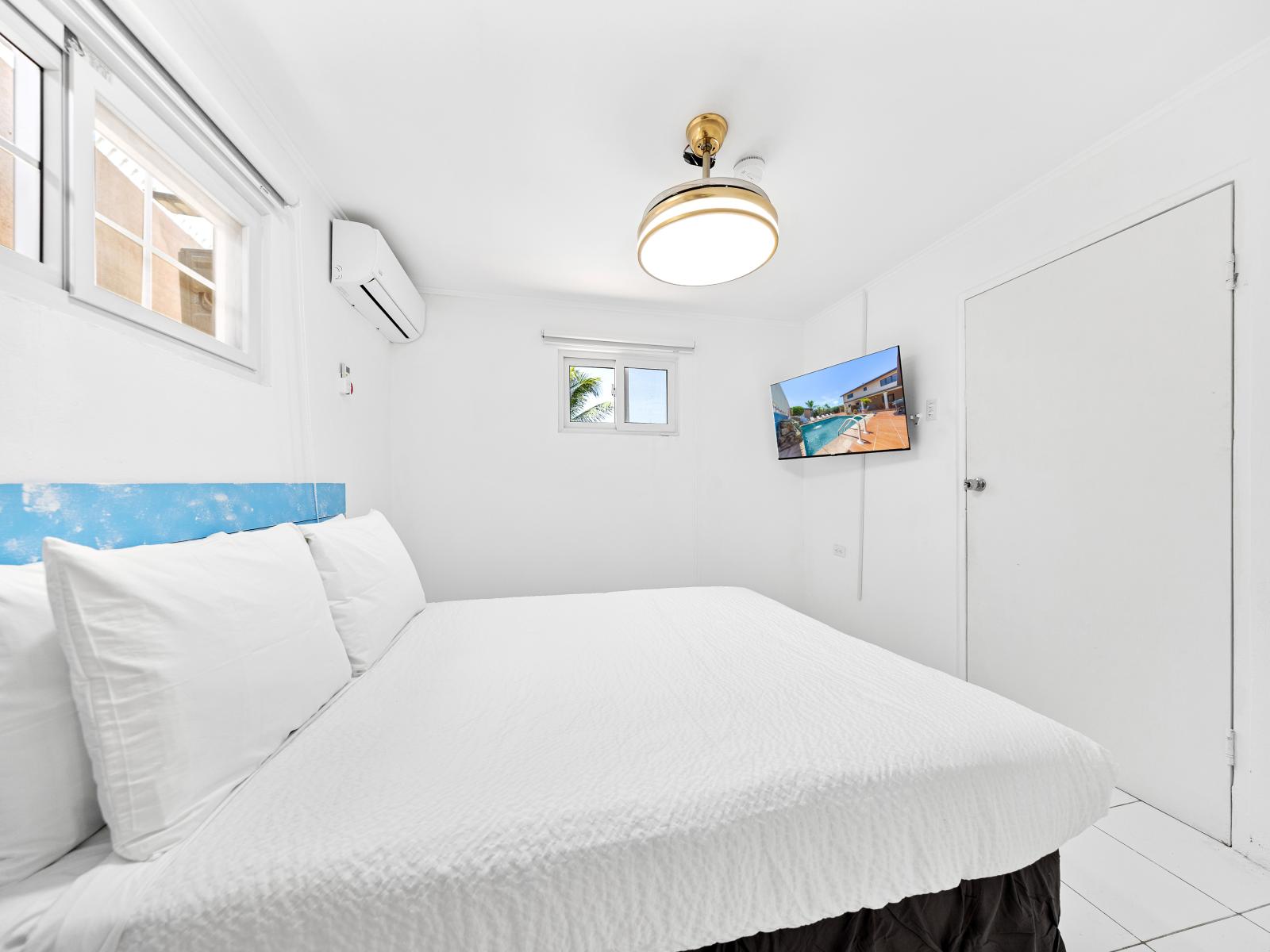 Escape to comfort and relaxation in this beautifully furnished bedroom of the home in Noord Aruba (Separate apartment) - Offers double bed and a wall mounted flat screen TV - Thoughtfully designed bedroom featuring functional and stylish furniture