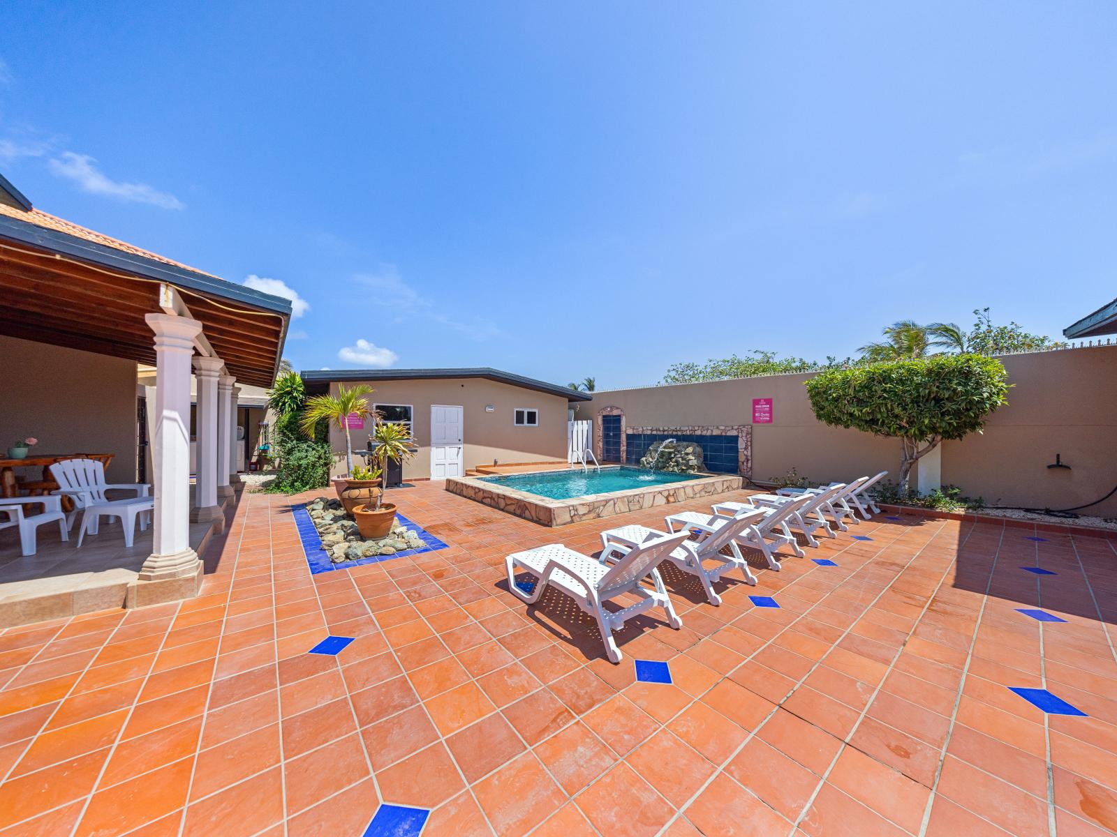 Soak up the sun by the private pool of the home in Noord Aruba - Shaded seating providing a cool retreat from the sun - Sparkling waters beckoning you to take a leisurely swim