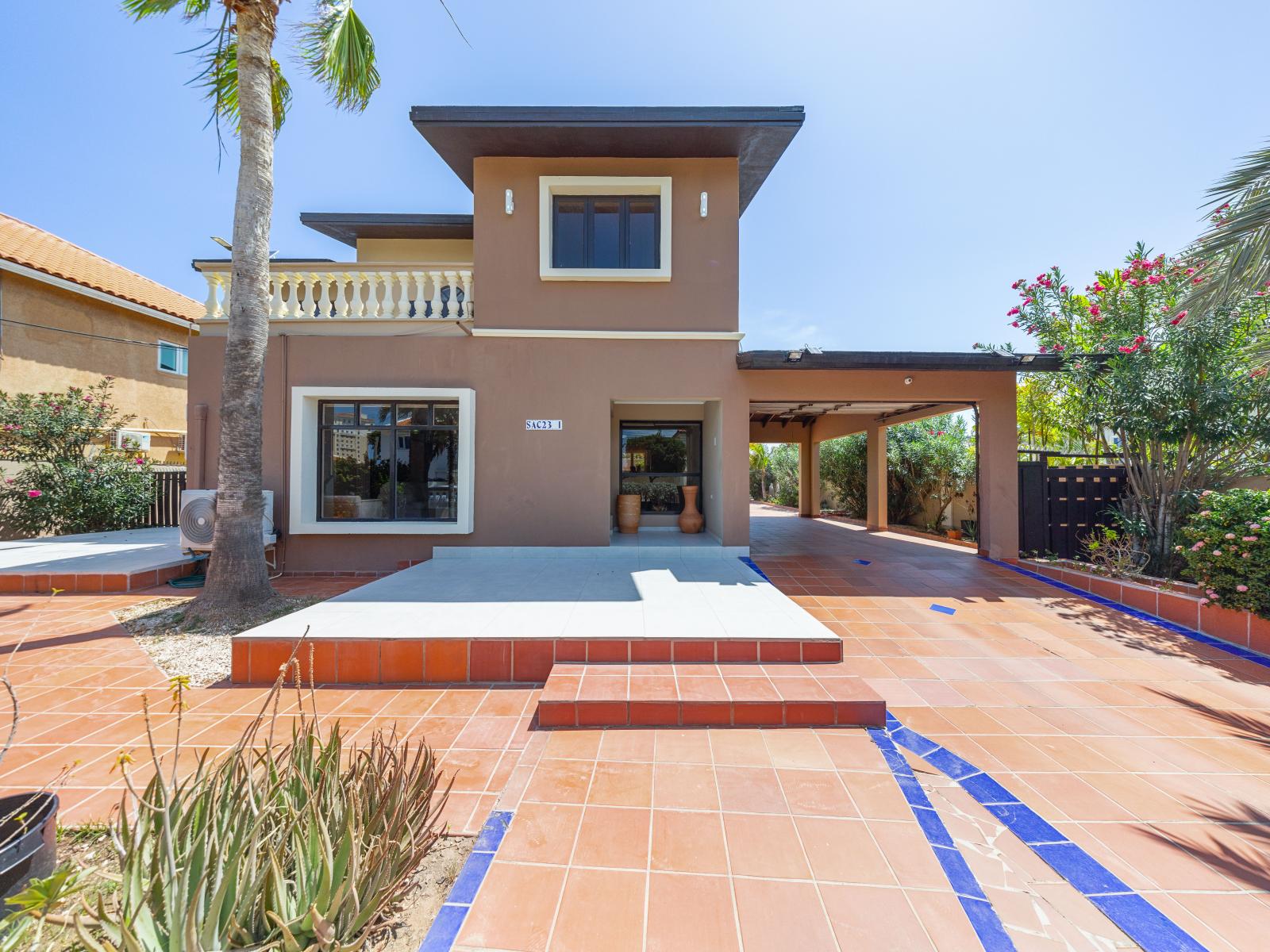 Front entrance of the home, private balcony of the second floor with beautiful sunset views in Noord Aruba - Enter into relaxation as you open the door to welcoming abode - Experience the perfect blend of elegance and comfort while your stay