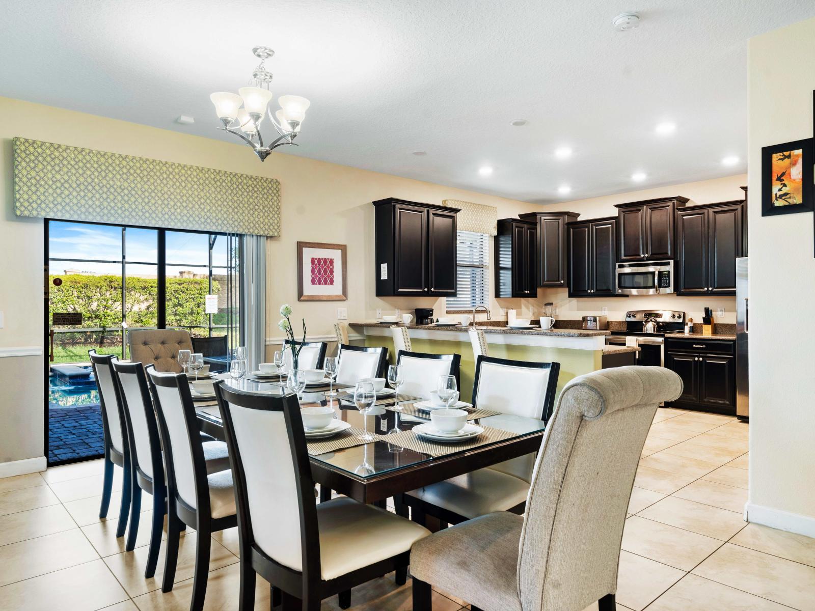 Elegant dining area with a stylish table set, perfect for family meals - Fully-equipped kitchen featuring high-end appliances and ample counter space for culinary adventures - Bright and welcoming ambiance with easy access to outdoors