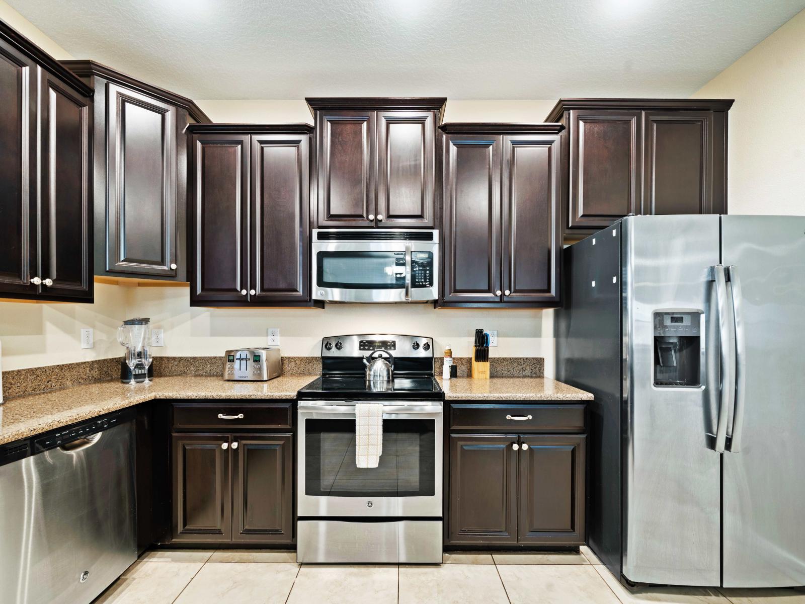 Experience culinary bliss in our modern, fully equipped kitchen of the home in Four Corners Florida - Enjoy the spacious and inviting atmosphere with plenty of storage - Harmonious blend of practicality and contemporary aesthetics