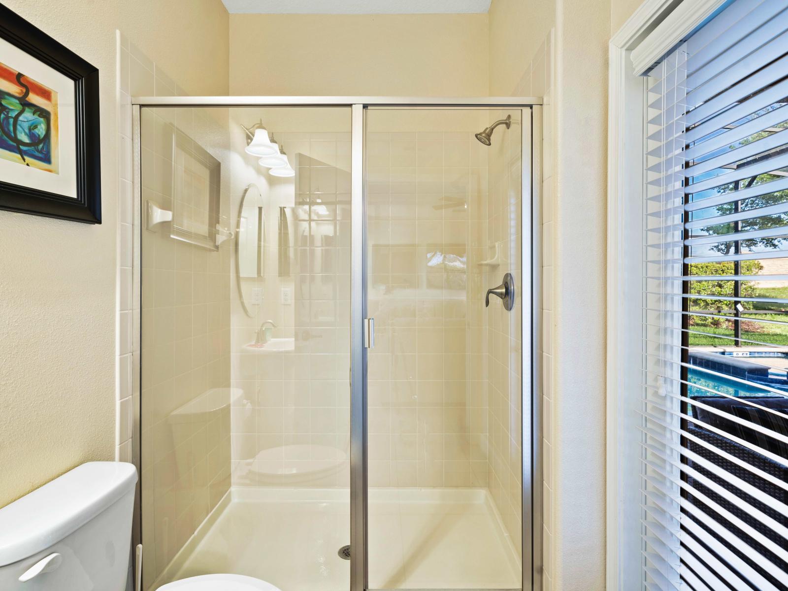 Escape to serenity in the beautifully crafted and immaculately clean bathroom - Spacious glass enclosed walk-in shower area exuding elegance with quality fixtures - Enjoy a serene ambiance brought by a sophisticated color palette