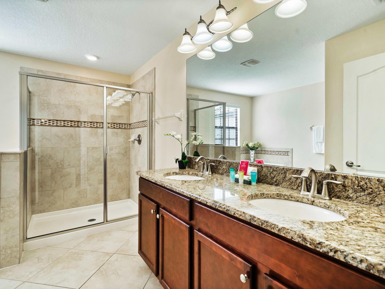 Unwind after a day of adventure in the sleek and stylish bathroom with upscale lighting - A bathroom exuding elegance with luxurious fixtures and finishes - Clean lines and refined details for a sophisticated look