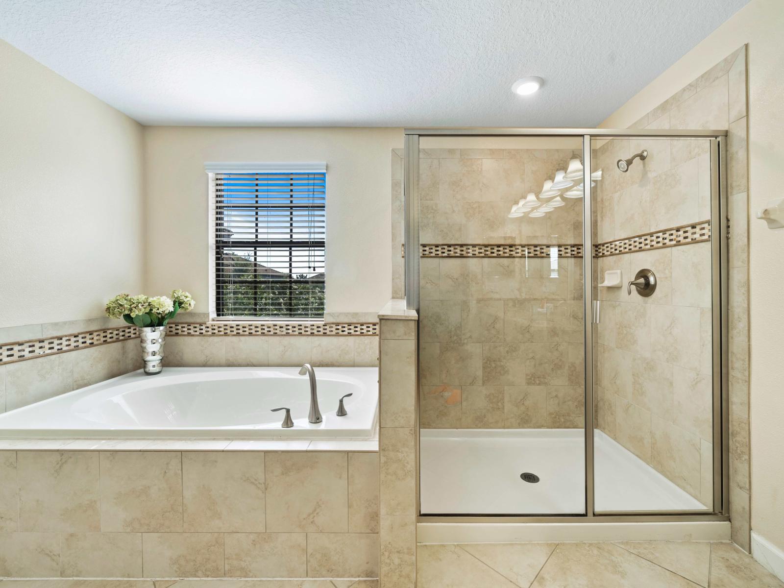 Luxuriate in the comfort of our well-appointed bathroom retreat with bathtub and shower area - Immerse yourself in a spa-like ambiance featuring a modern, stunning bathtub - A glass-enclosed shower brings a modern edge to the seamless design