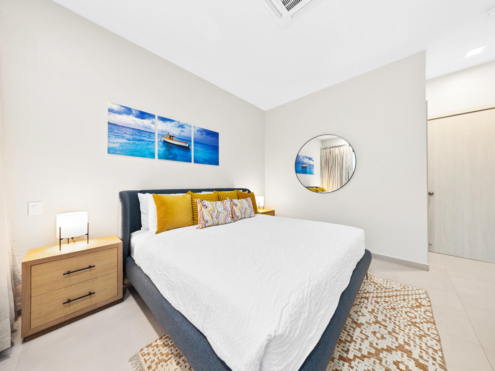 Discover charm in cozy bedroom of the apartment in Noord Aruba - Features an attached bathroom for privacy and convenience and a plush king size bed - Stylish furnishings lending a modern, elegant look offering and un forgettable experience