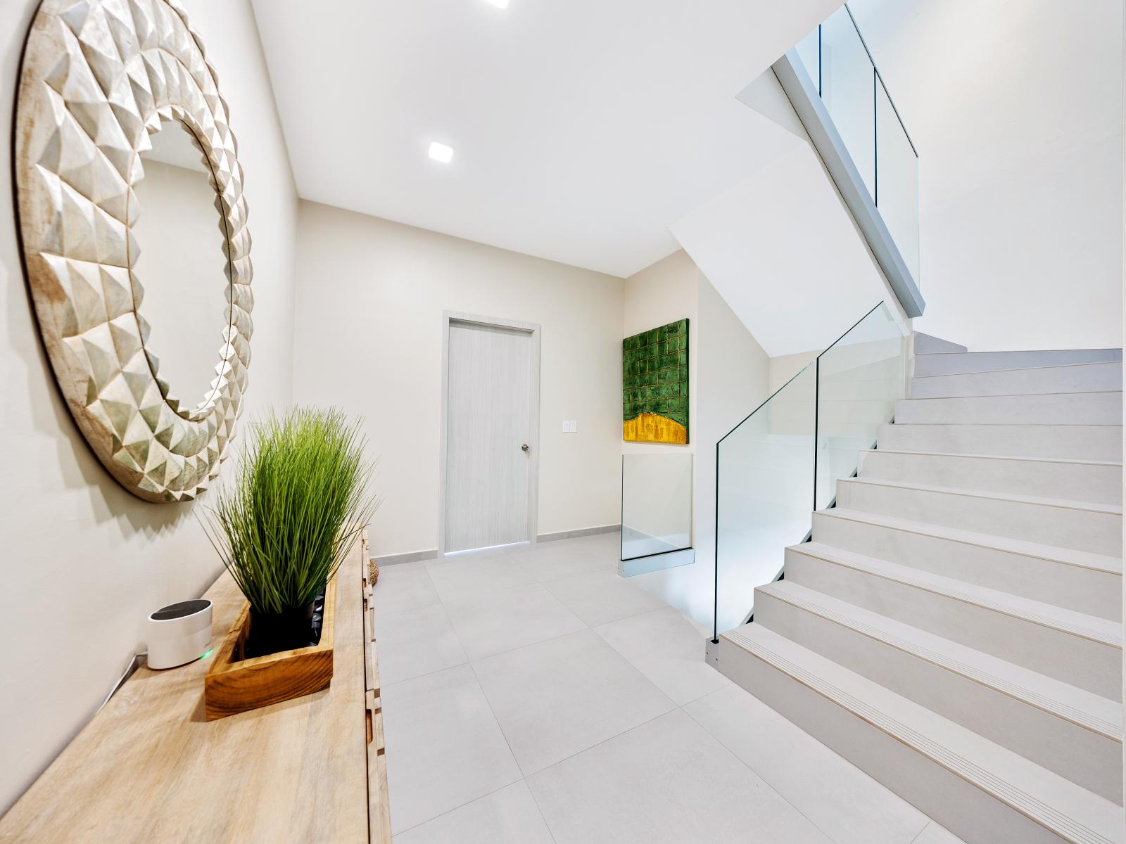 Stairs to the bedrooms of the apartment in Noord Aruba - A passage to comfort and style with thoughtfully curated decor adding personality - Stylish, contemporary furnishings enhancing the aesthetic and indoor plants for natures touch