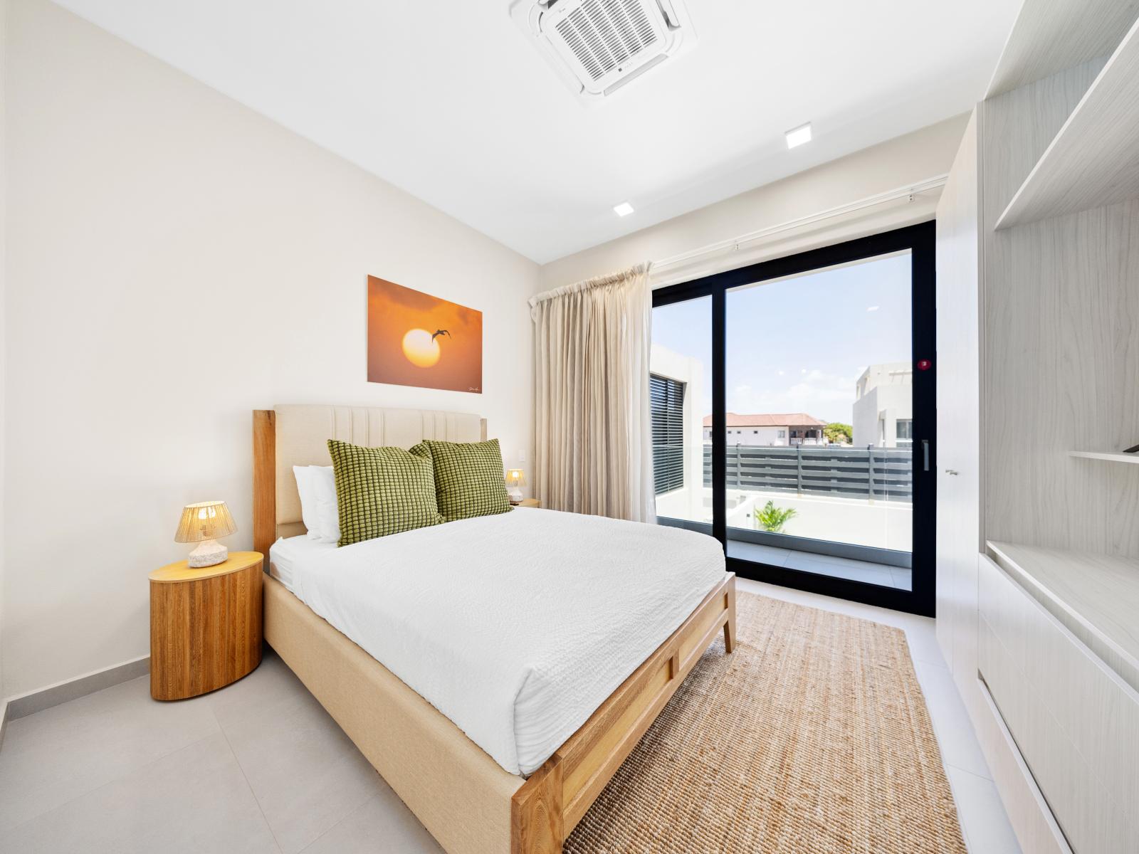 Experience the ultimate relaxation in second floor bedroom of the apartment in Noord Aruba - Where modern design meets comfort with a smart TV for a entertaining stay - Calming palette of neutral tones harmonizes with the tastefully furnishings