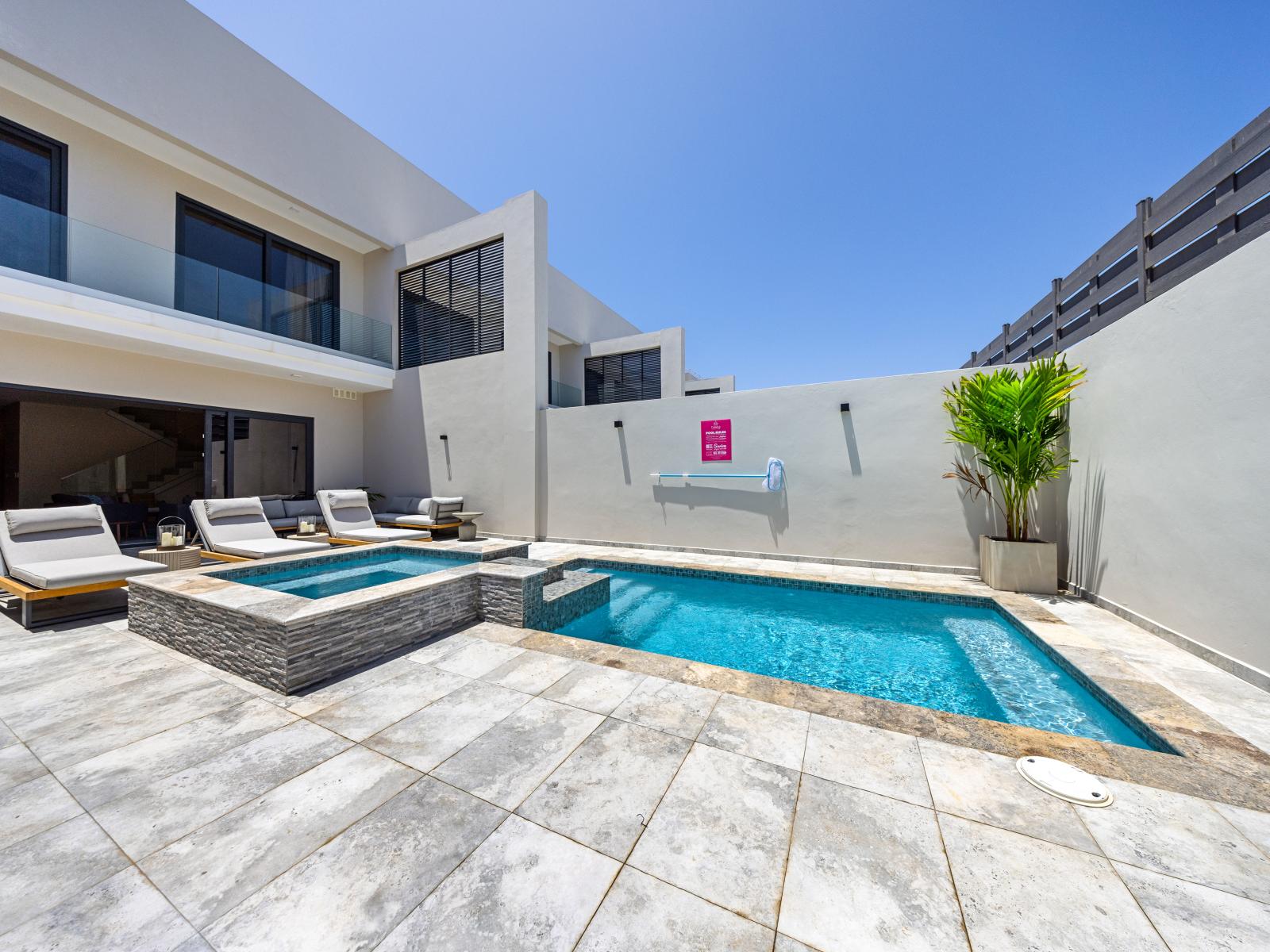 Soak and unwind in your private pool area of the apartment in Noord Aruba - Comfortable seating areas for enjoying cocktails with friends - A peaceful ambiance where you can unwind and recharge your spirits by the water