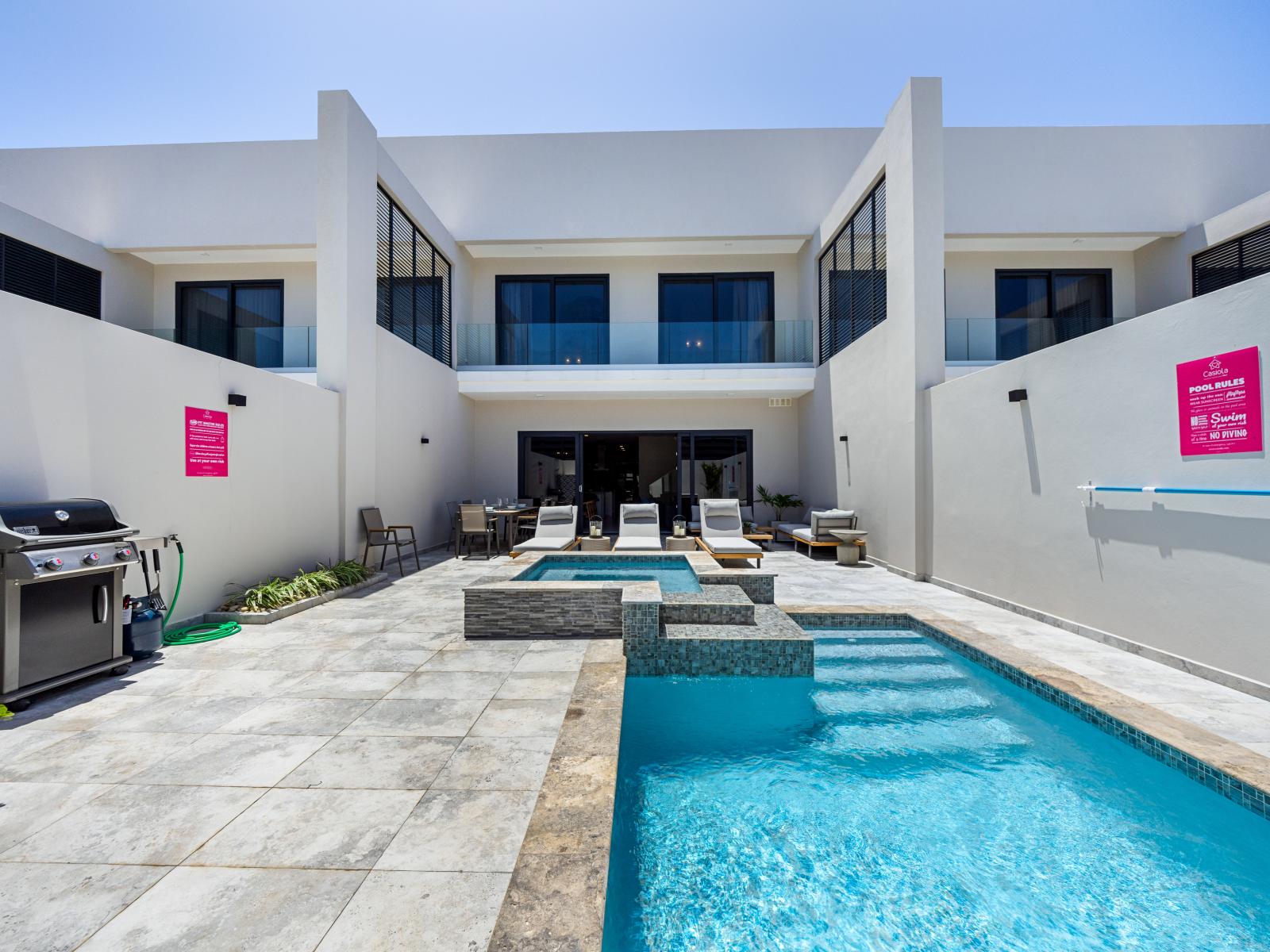 Experience the epitome of relaxation at the private pool of the apartment in Noord Aruba - Sun-kissed loungers and refreshing waters beckon for a day of leisure - BBQ grill, lush surroundings and gentle breezes create a serene ambiance