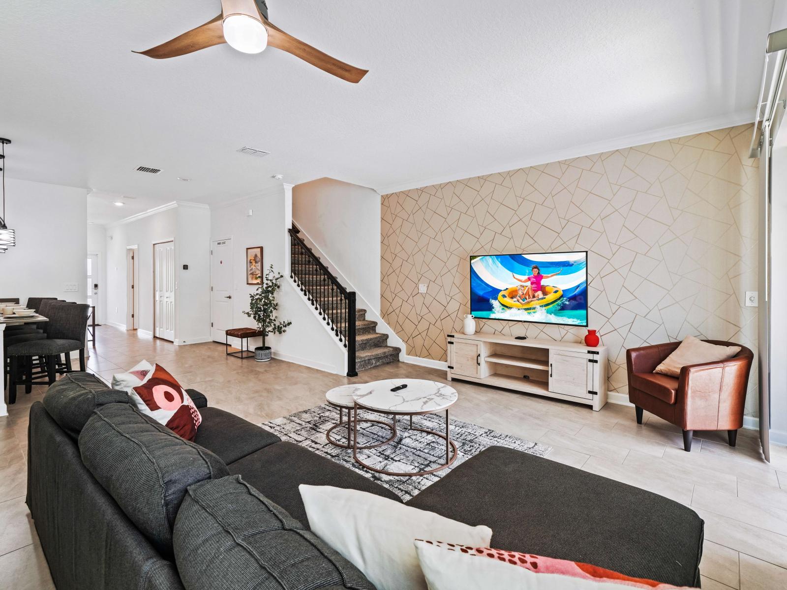 Unwind and recharge in the cozy living area of the townhouse in Davenport Florida - A balance of sophistication and comfort, featuring elegant yet inviting furniture - Open-concept living area seamlessly connected to a dining and kitchen