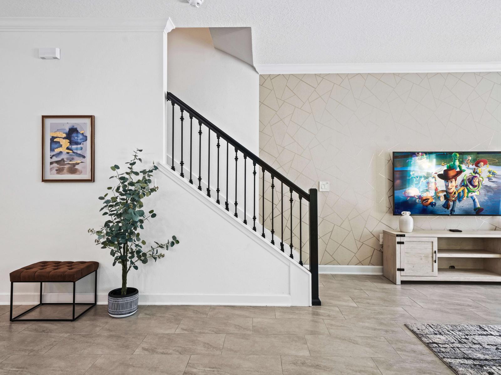 Find your sanctuary in meticulously designed living area of the townhouse in Davenport Florida - Artfully arranged plants introduce freshness and visual interest - Chic and contemporary living room design with clean lines and modern furnishings