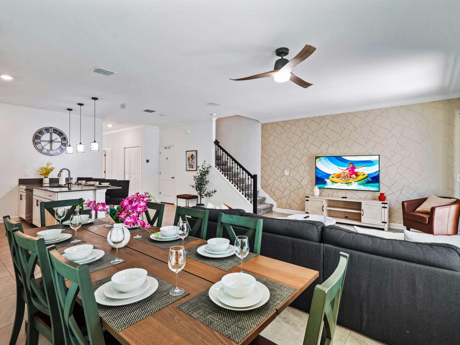 Entertain with ease in open-concept dining area of the townhouse in Davenport Florida - Featuring a stylish table and contemporary seating for 8 persons - Understated elegance with a focus on clean lines and sleek design for memorable meals