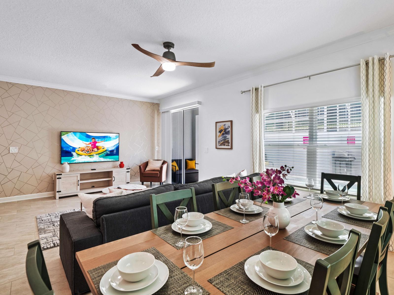 Dine in elegance in a thoughtfully furnished dining area of the townhouse in Davenport Florida - Seamless integration of natural elements, like flowers, for a fresh touch - Comfortable seating designed for lingering meals with loved ones