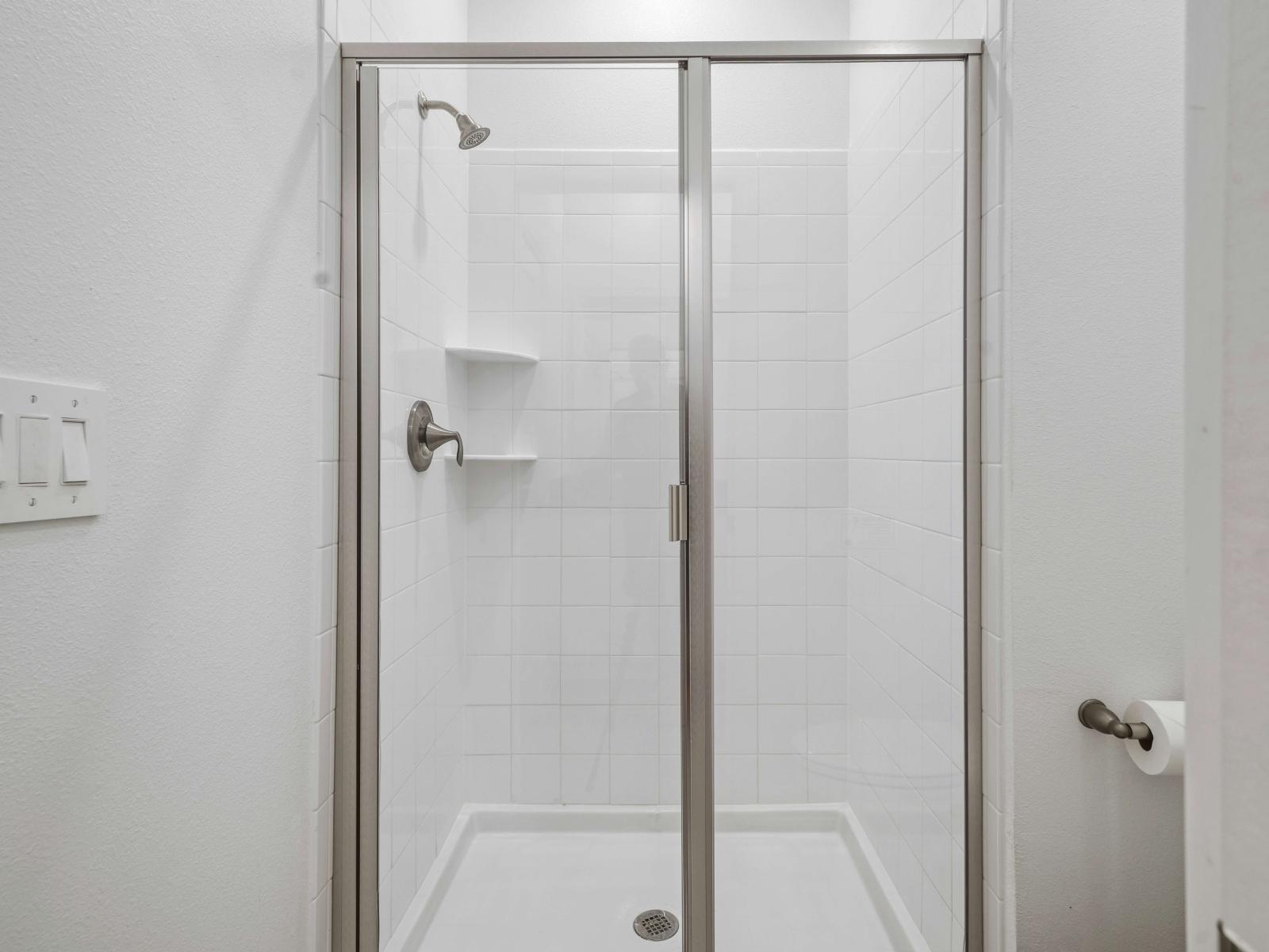 Indulge in pampering in an elegantly designed bathroom of the townhouse in Davenport Florida - Seamless design featuring a glass-enclosed shower for a modern touch - Harmonious blend of classic and contemporary elements