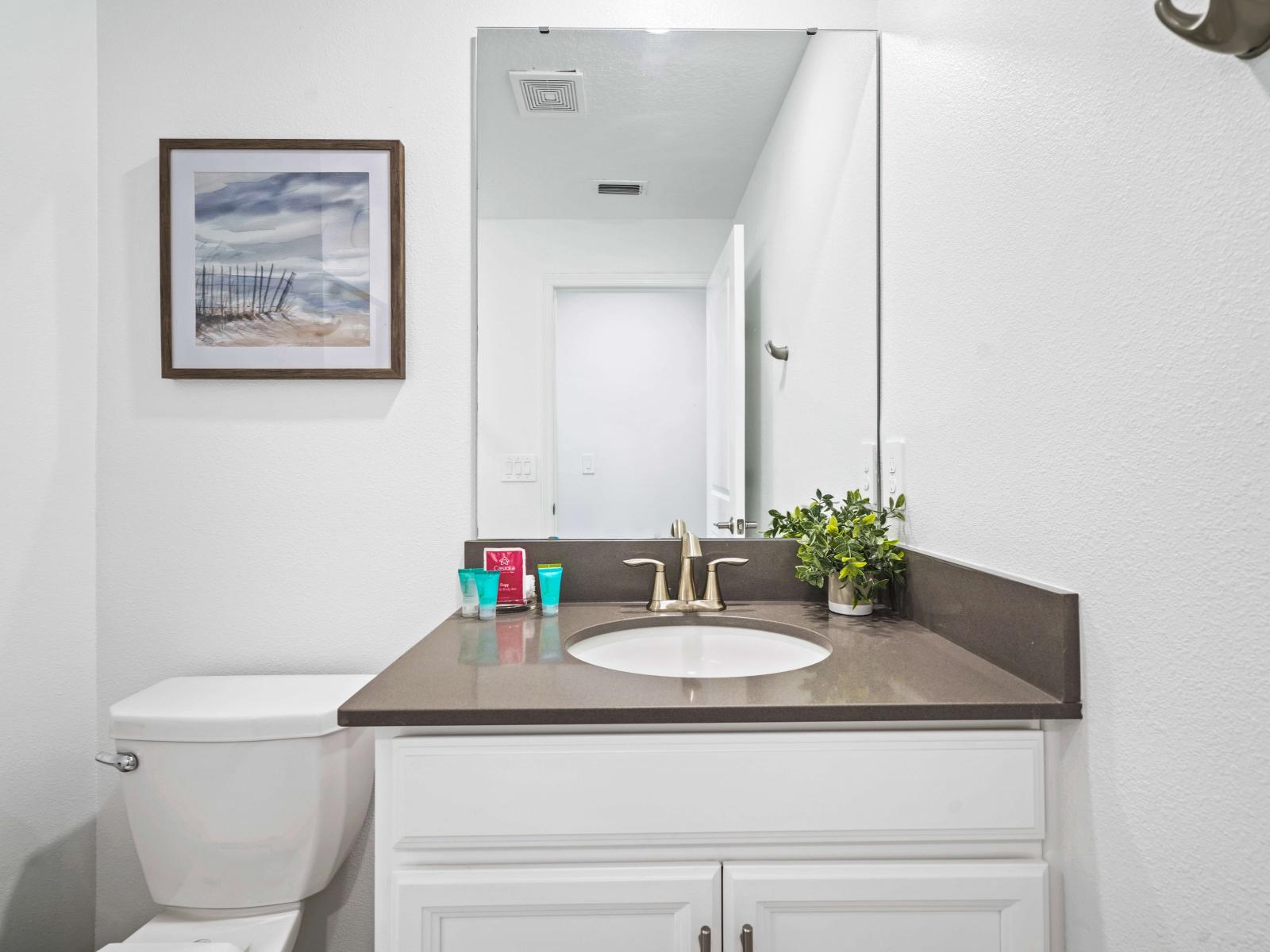 Experience the ultimate in comfort in a chic bathroom of the townhouse in Davenport Florida - With a modern glass-enclosed shower for added sophistication - Functional yet glamorous, with thoughtfully chosen fixtures