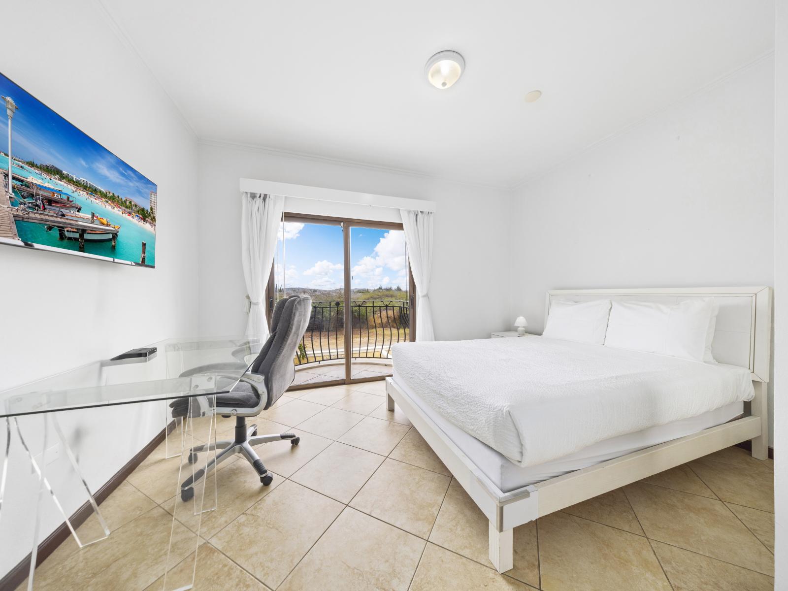 Bedroom 1 features a queen size bed access to the private balcony with glass sliding doors