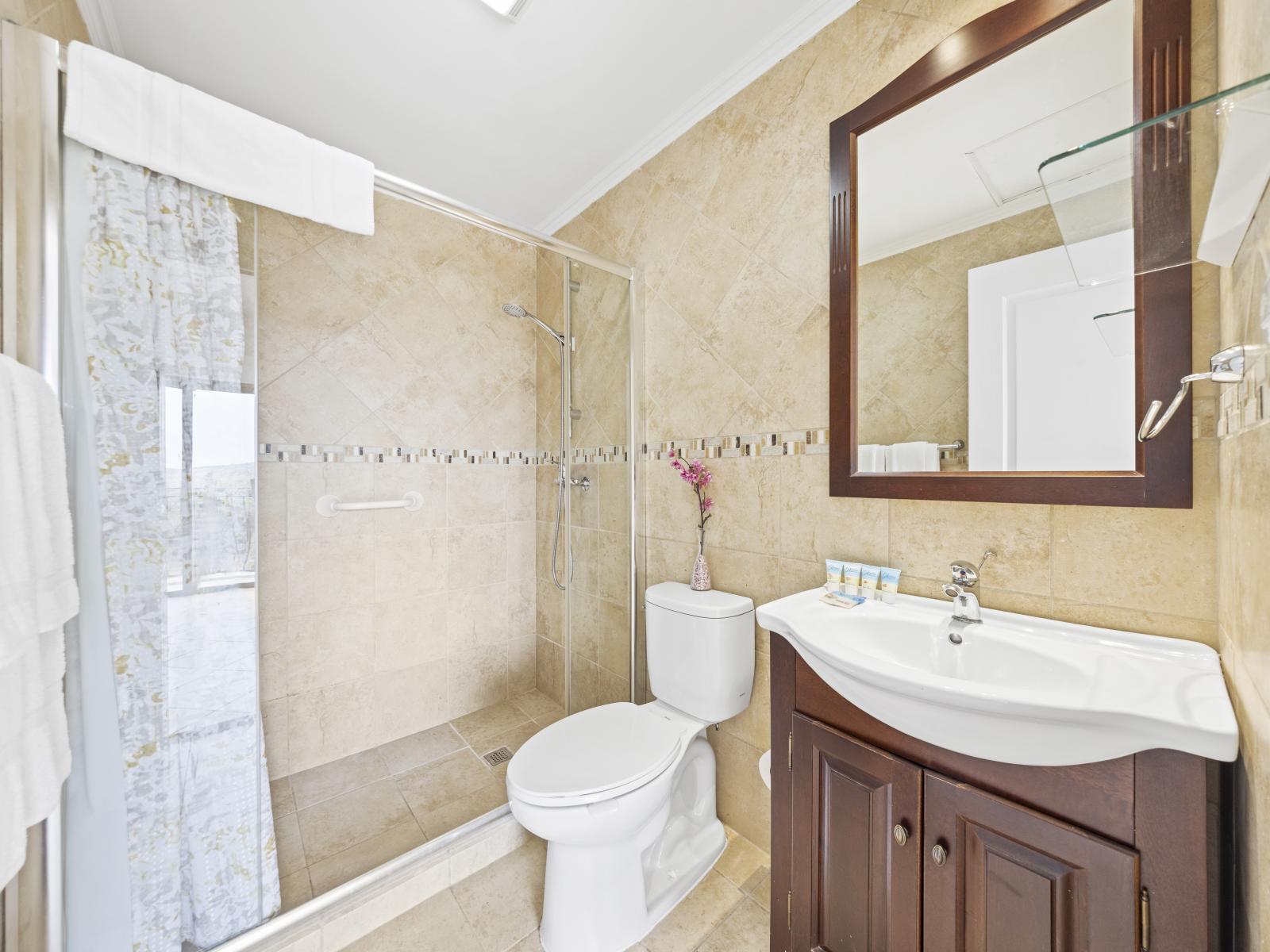 Step into luxury: the second bedroom's bathroom features a spacious walk-in shower for a rejuvenating experience.