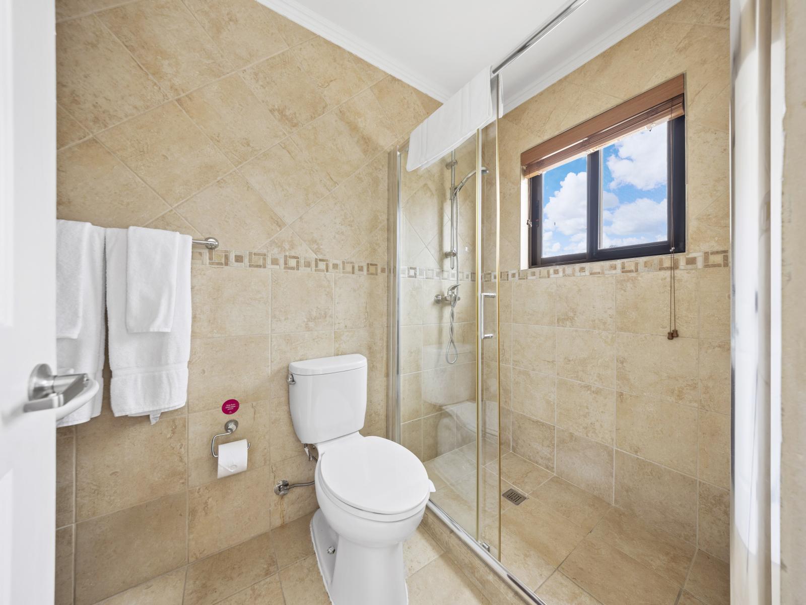 Embrace modern elegance in the third bedroom's bathroom, featuring a luxurious walk-in shower.