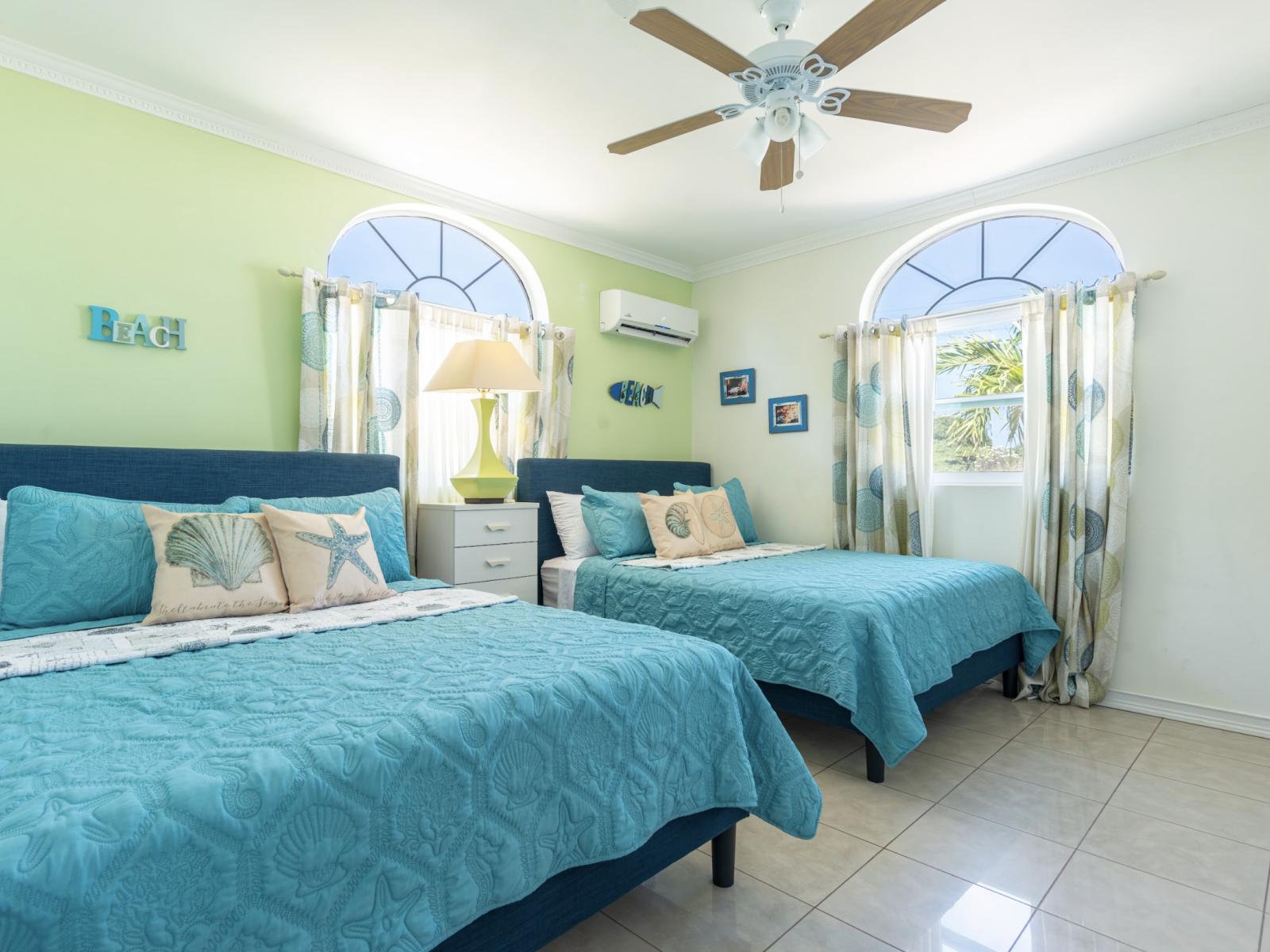 Embrace the essence of elegance and comfort in the bedroom of the home in Noord Aruba - Offers two queen size beds for restful night after long day for beach day fun -  Bedroom with a cozy ambiance, blending comfort and aesthetics