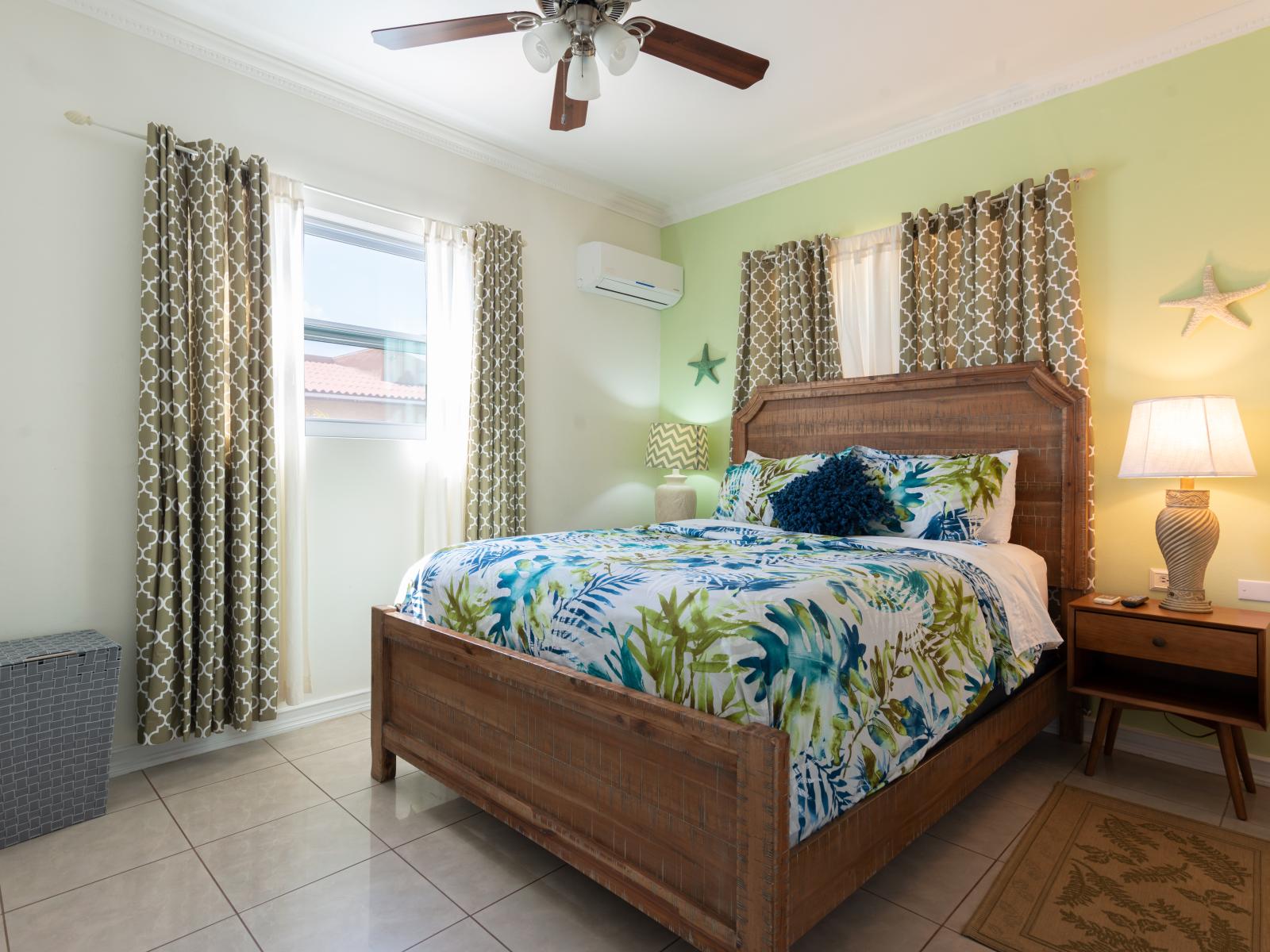 Wrap yourself in comfort in our tranquil bedroom of the home in Noord Aruba - Features a queen size bed and warm atmosphere with plenty of natural light - Thoughtfully designed bedroom featuring functional and stylish furniture