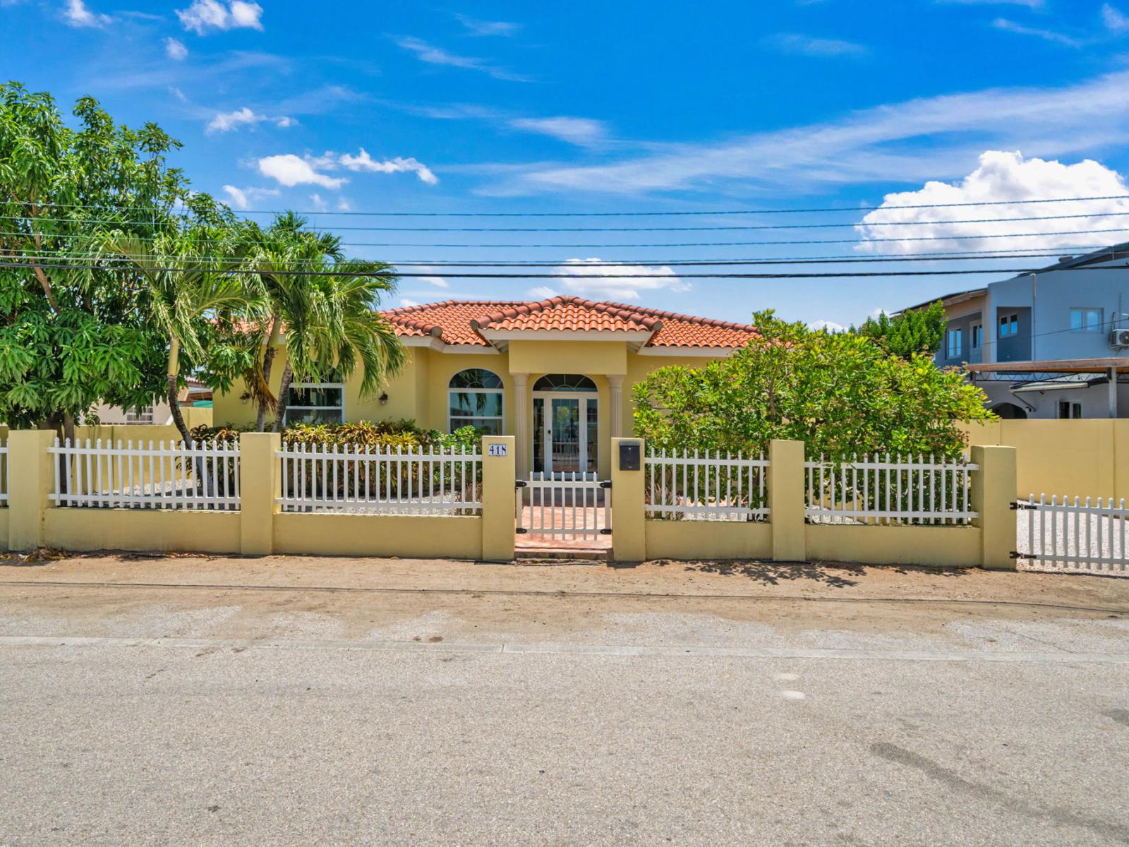 Discover the epitome of curb appeal with our picturesque front facade in Noord Aruba - Step into a world of comfort and hospitality as you approach welcoming home - Start your getaway off right with the charming allure of front entrance