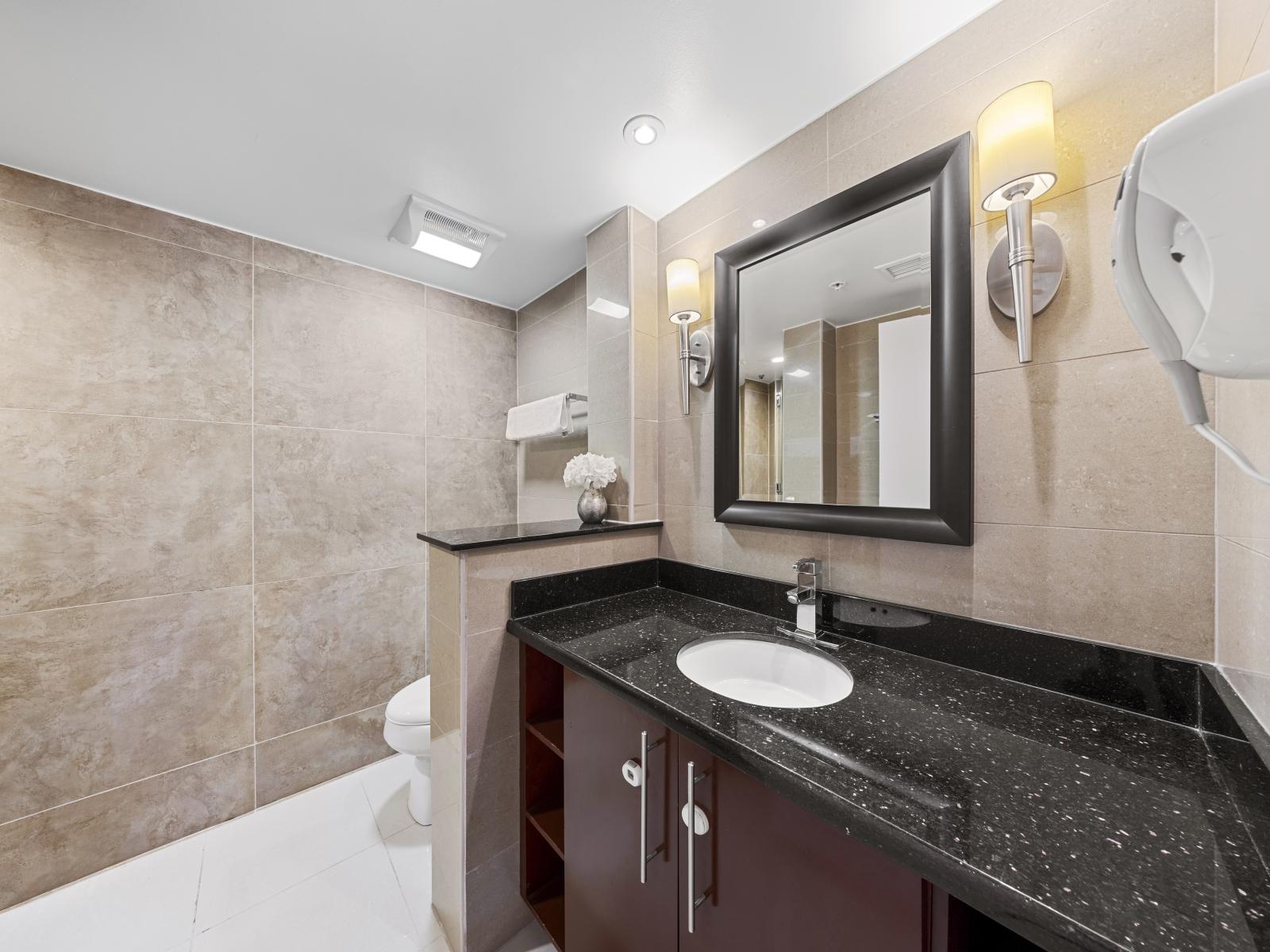 Embrace modern elegance in the second bedroom's bathroom, complete with a luxurious walk-in shower