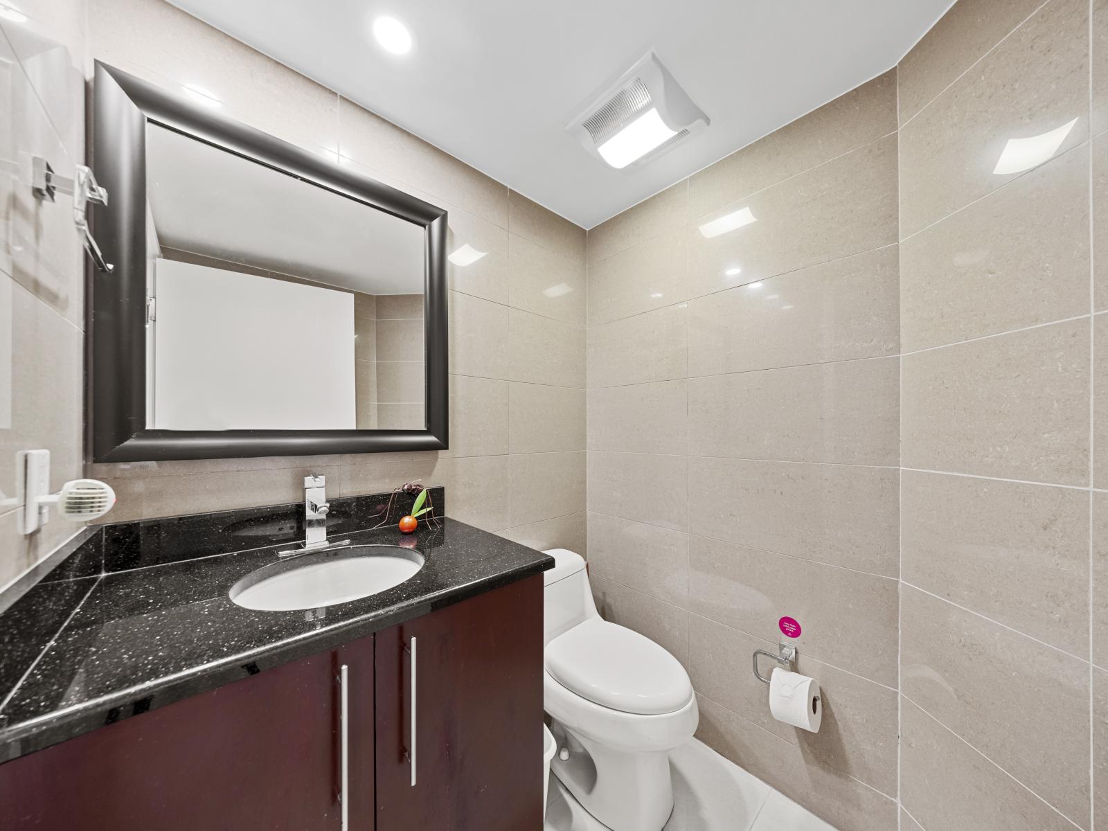 The bathroom in the fifth bedroom boasts stylish fixtures and a clean, inviting atmosphere, ideal for relaxation.