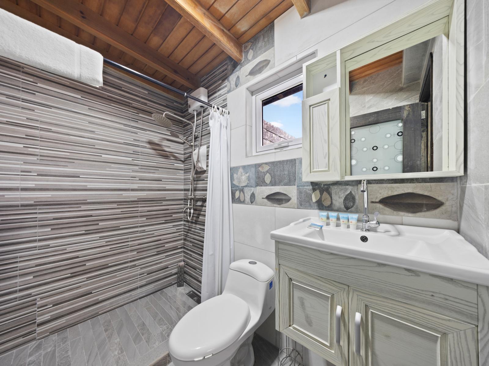 Relax and unwind in this stylish bathroom located in the separate house - Soft, ambient lighting and tasteful decor create an inviting atmosphere - Classic and contemporary elements blend harmoniously throughout