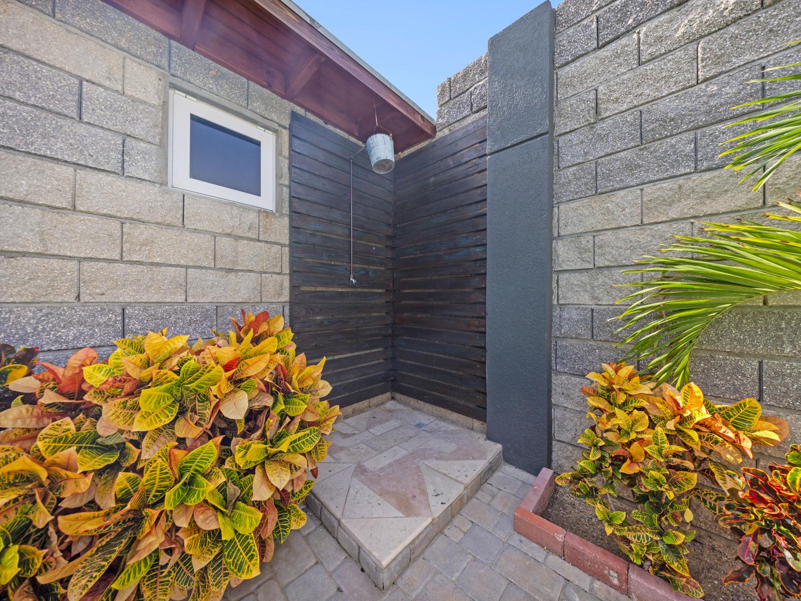 Refreshing outdoor shower of the home in Aruba - Dive into luxury in your own private pool, where relaxation and indulgence await - Find solace in the simplicity of outdoor space, where worries fade away