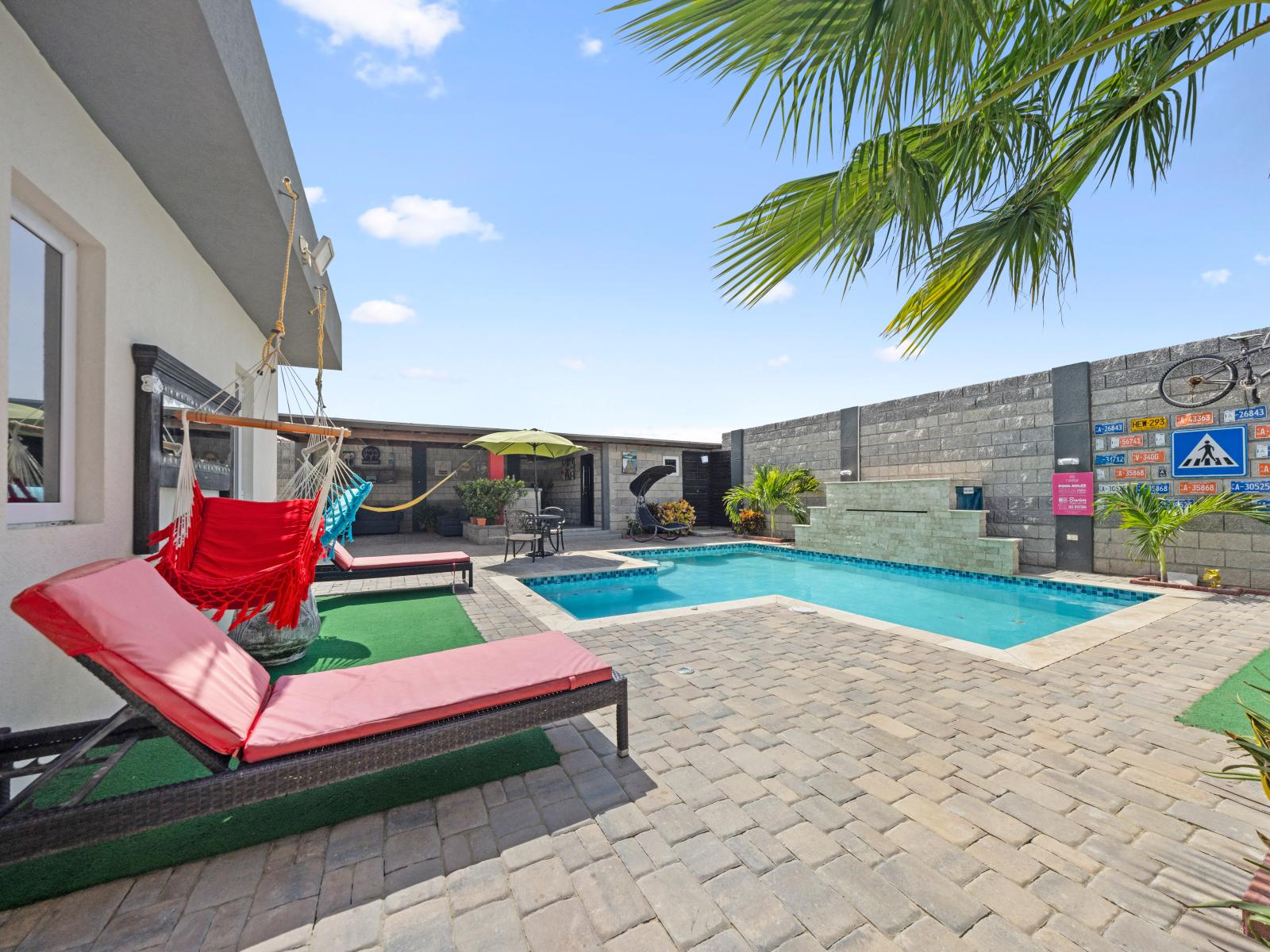 Immerse yourself in serenity with this inviting pool of the home in Aruba - A peaceful atmosphere where you can relax and create unforgettable memories - Serene escape where you can unwind and rejuvenate in style with plenty of seating