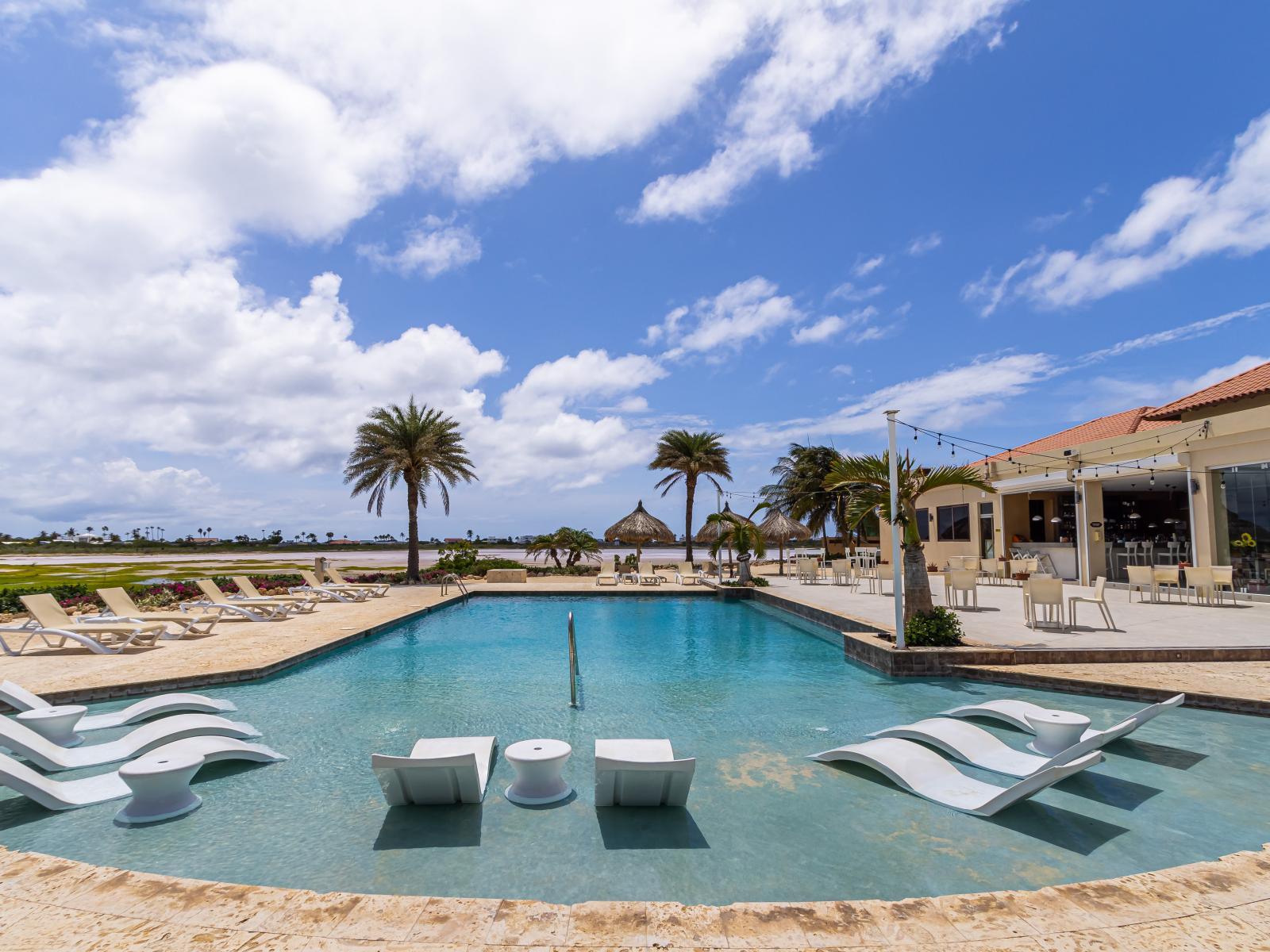 - Enjoy a dip in our resort's shared pool area in Noord, Aruba - A perfect spot for cooling off and unwinding - Lounge by the poolside and soak up the sun with the convenience of cozy beach chairs - Our resort's pool is designed for ultimate leisure