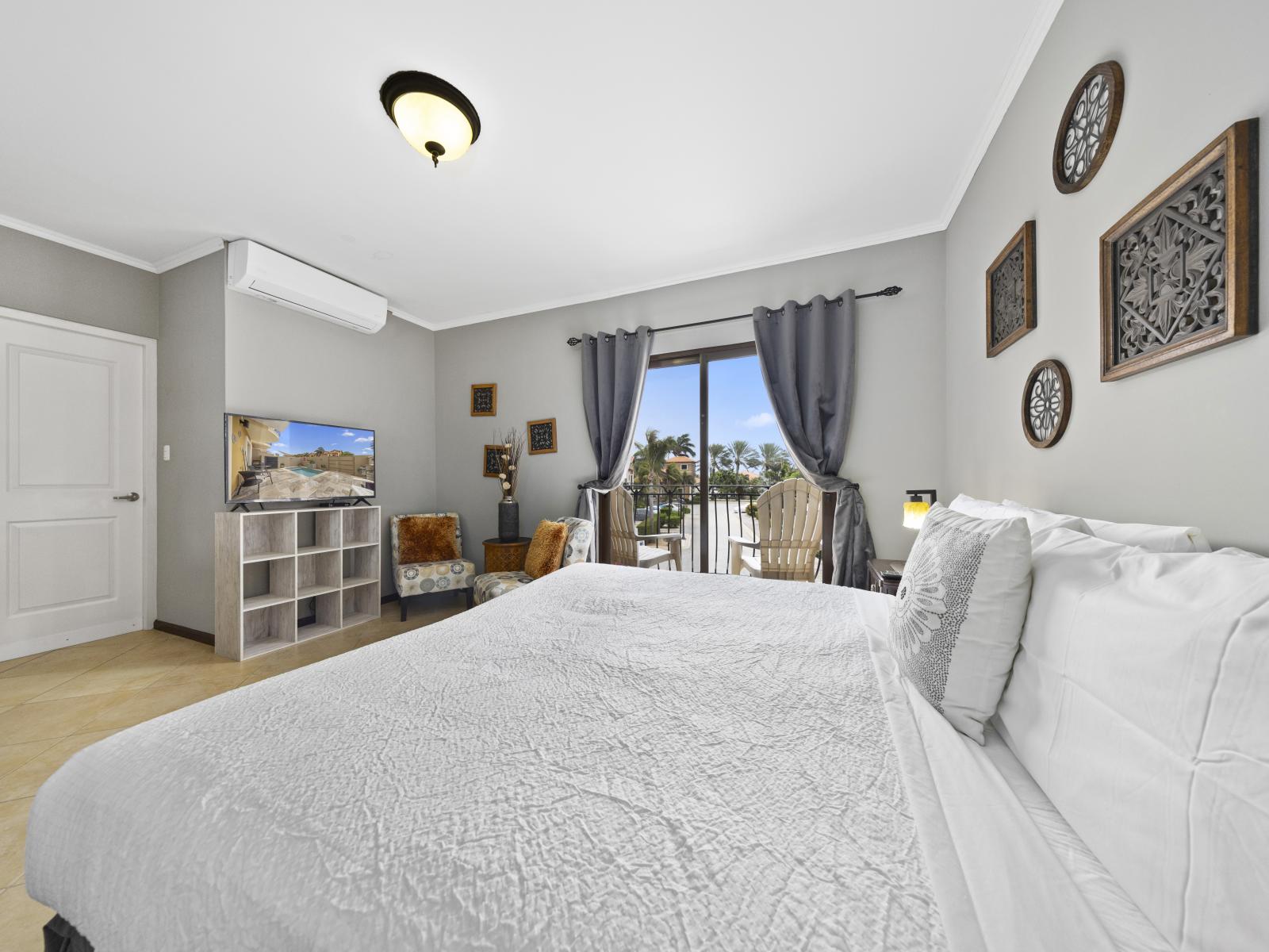 - Unwind in the gloriously designed townhouse bedroom in Noord, Aruba. - Sink into the soft and comfortable bed featuring a crisp linen. - The bedroom is a peaceful retreat with a private balcony. - Enjoy the availability of smart TV and Netflix