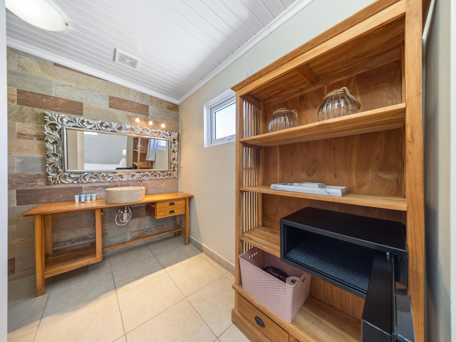 Indulge in the elegance of this classy bathroom of the home in Oranjestad, Aruba - Relax in spa-like atmosphere with luxurious walk-in shower area  perfect for unwinding after a long day - Wrap yourself in plush, high-quality towels and toiletries