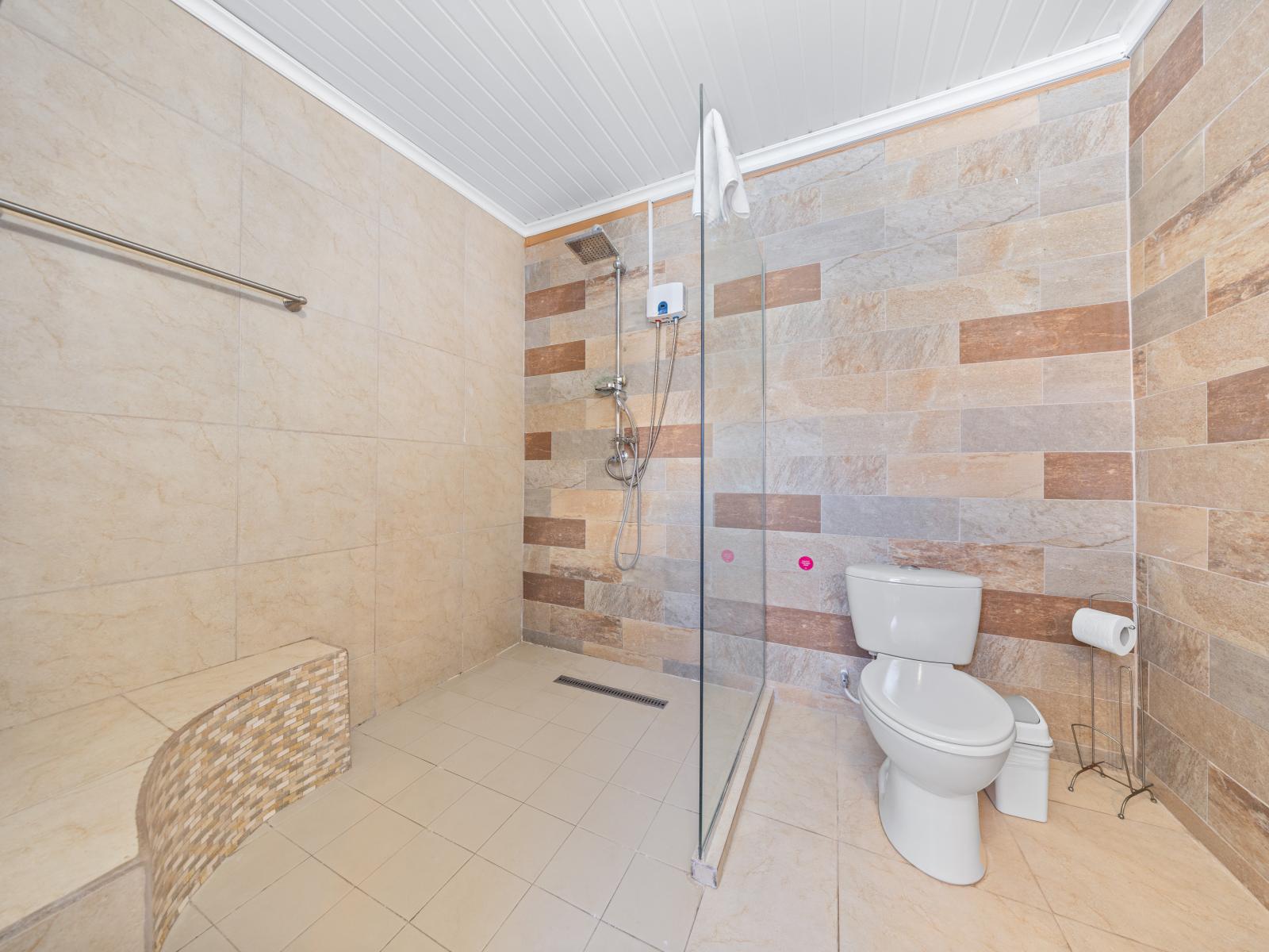 Experience pure luxury in this gloriously appointed shower area in the bathroom of the home in Oranjestad, Aruba - Enjoy the soothing sensation of a rainfall showerhead, offering a spa-like experience in the comfort of your own bathroom