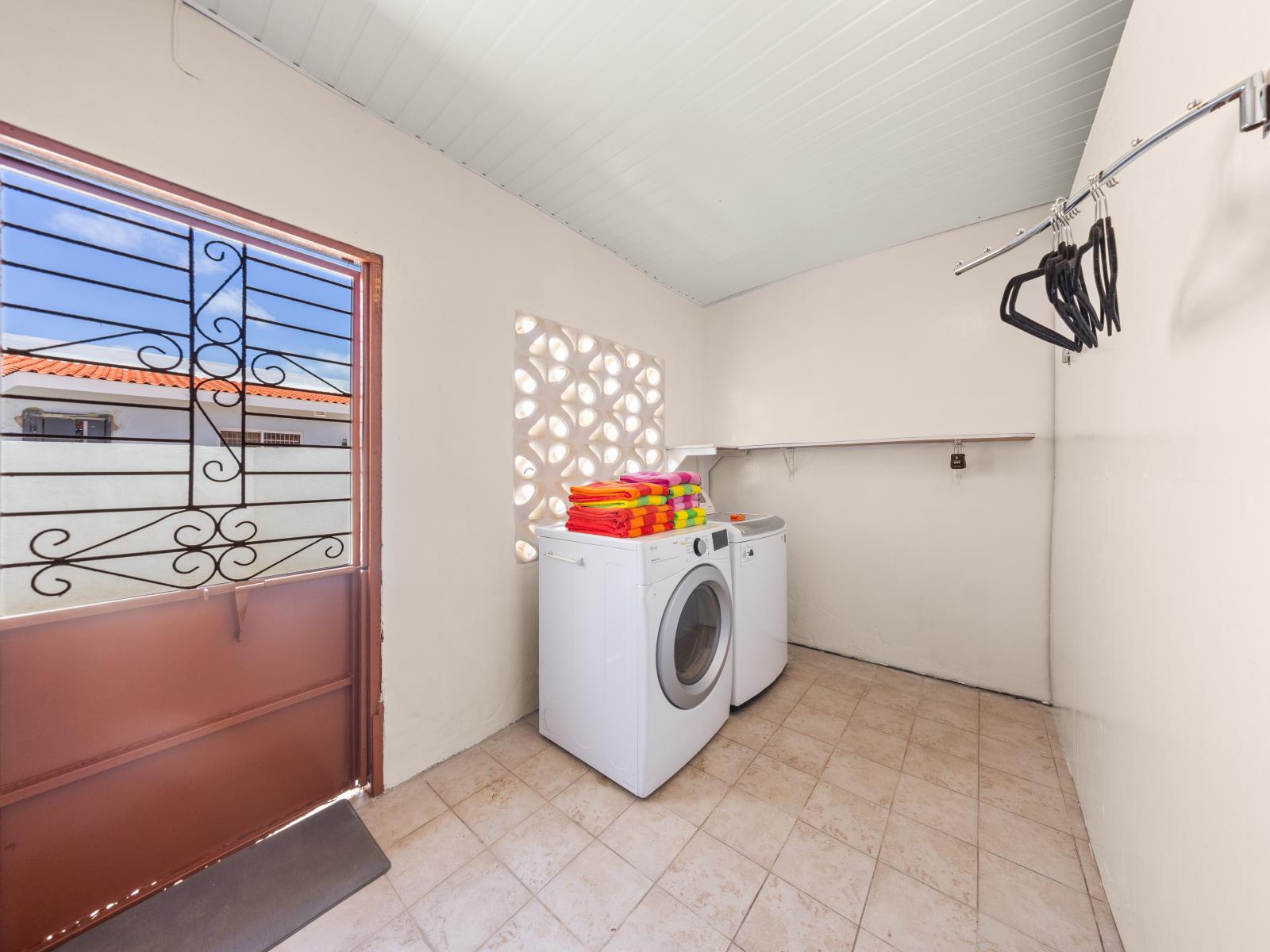 Enjoy the convenience of in-home laundry facilities of the home in Oranjestad, Aruba - Equipped with modern washer and dryer for efficient and hassle-free laundry days - Keep things organized and make laundry routines smooth and efficient