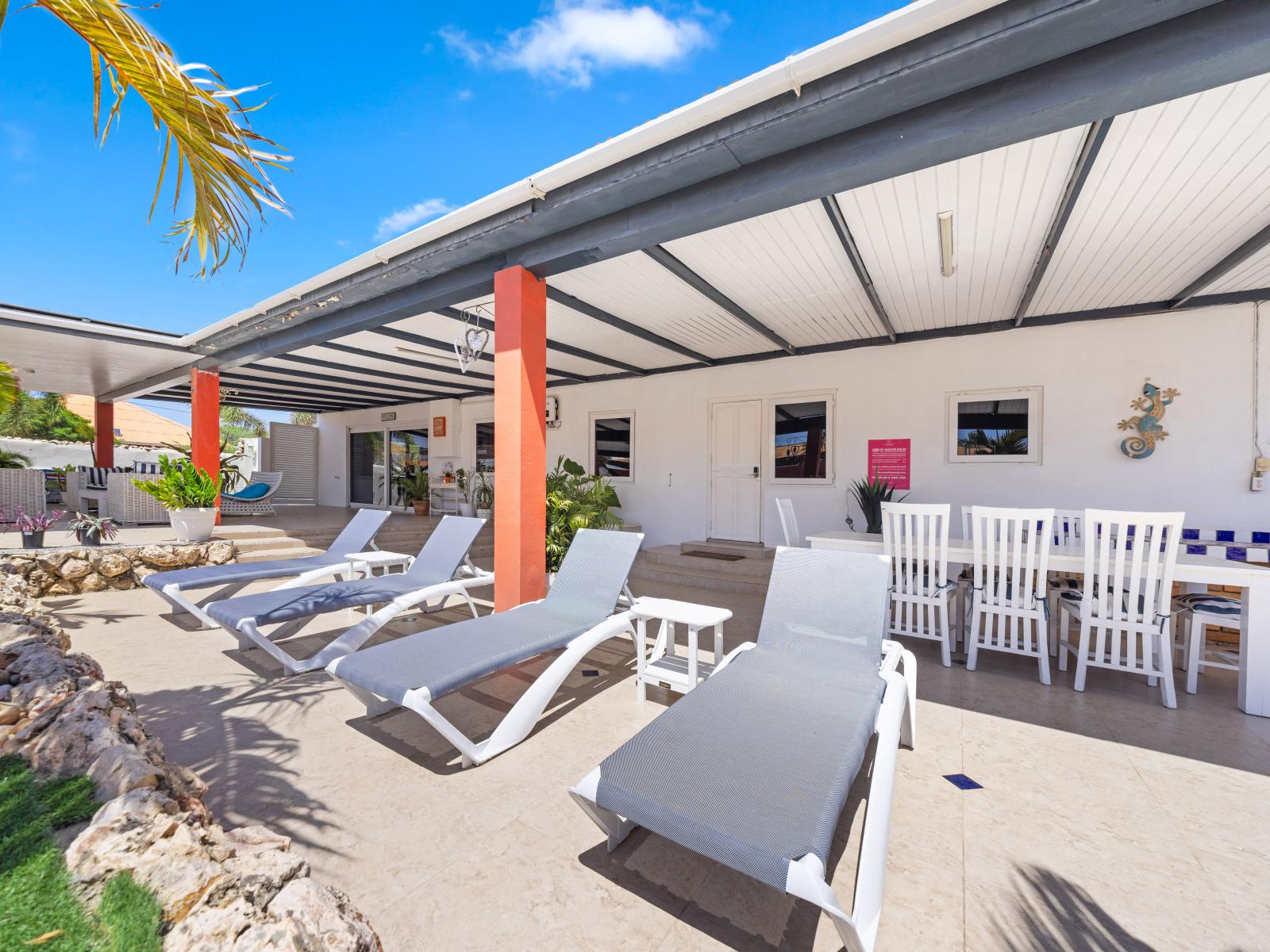 Host poolside gatherings with amazing pool area of the home in Oranjestad, Aruba - Relax on plush lounge chairs, ideal for soaking up the sun or enjoying a good book - Retreat to shaded cabanas for a moment of relaxation and privacy by the pool