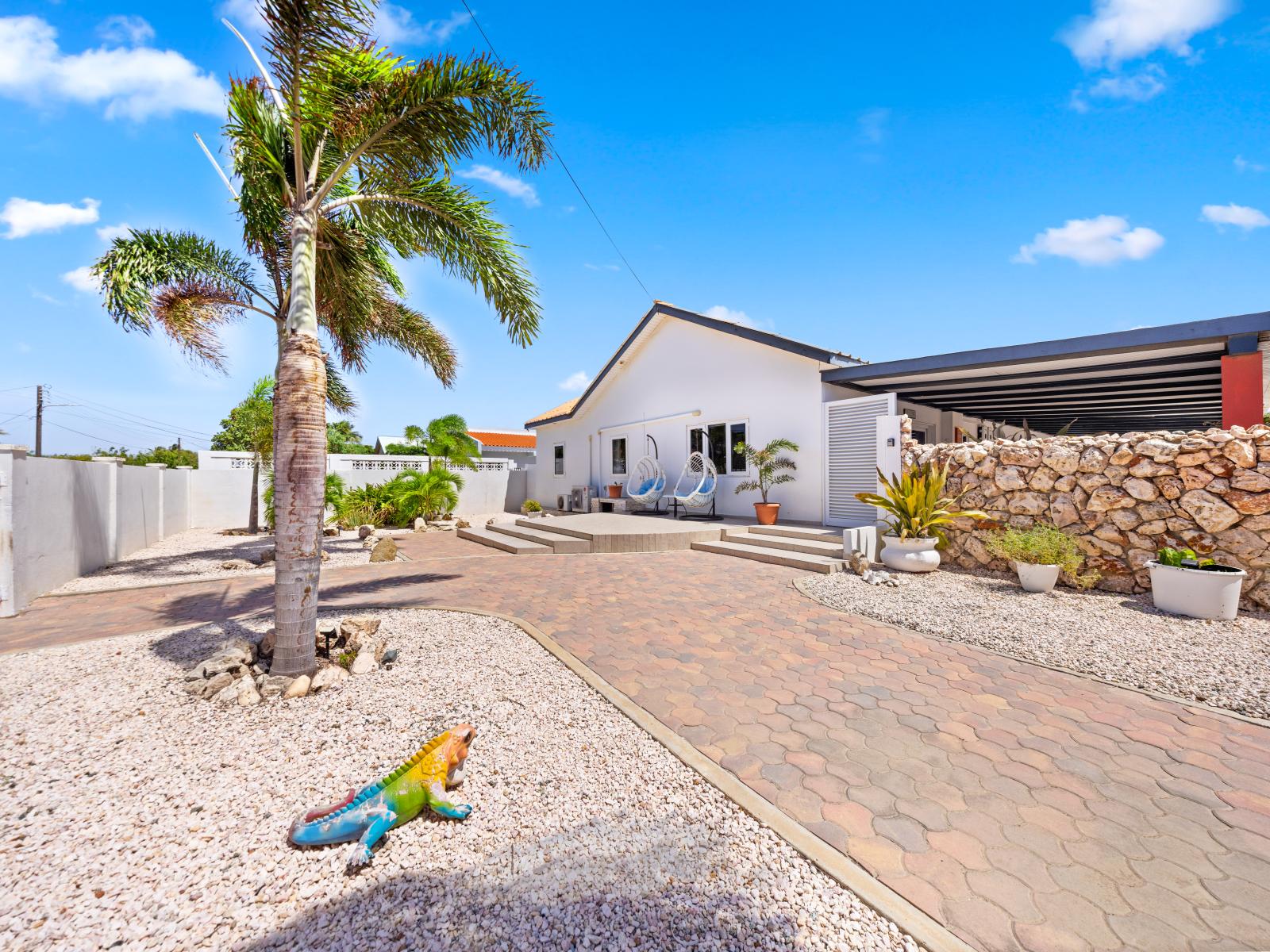 Admire the inviting charm of our home's exterior in Oranjestad, Aruba - Step through the welcoming front entrance, designed to make you feel at home - The stunning facade of our home features a harmonious blend of classic and modern design