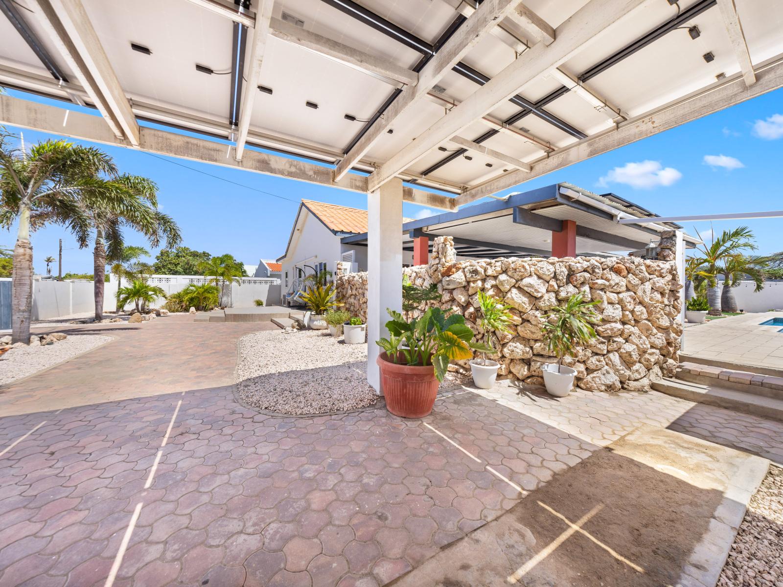 Admire the charming architecture of this beautiful home exterior in Oranjestad, Aruba - The home's elegant design features a blend of modern and classic elements - This home boasts stunning curb appeal that will impress you upon arrival