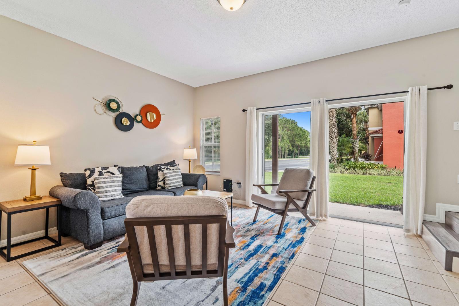 Relax and unwind in inviting and spacious living area of the townhouse in Kissimmee Florida - Cozy seating encourages relaxation and socializing, designed to be both inviting and relaxing - Easy access to outdoors though the sliding glass door