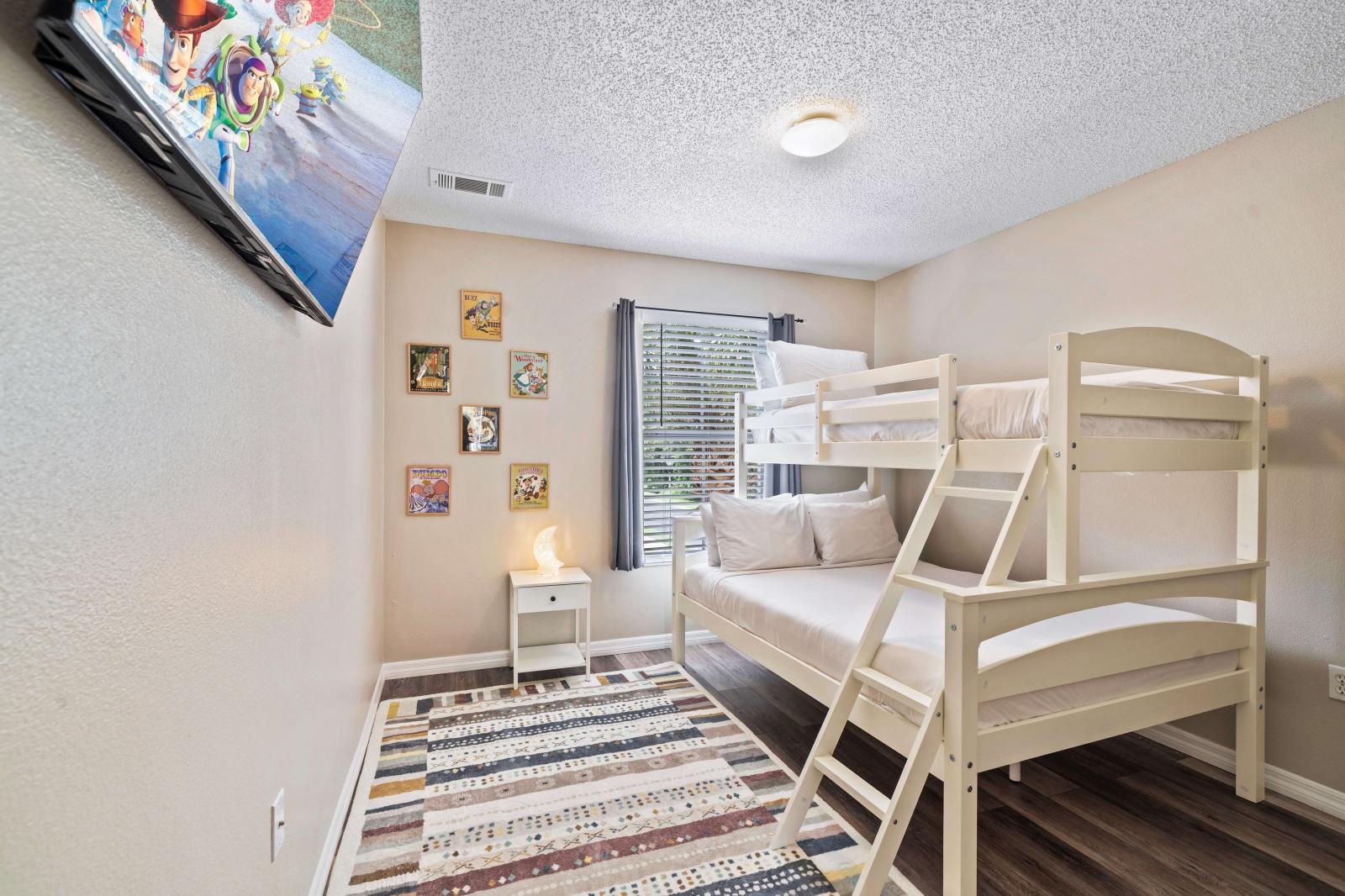 This charming bedroom is perfect for kids , featuring sturdy bunk bed with a twin over full configuration - Decorated with playful artwork and includes a flat-screen TV, providing entertainment - Designed to ensure a comfortable and enjoyable stay