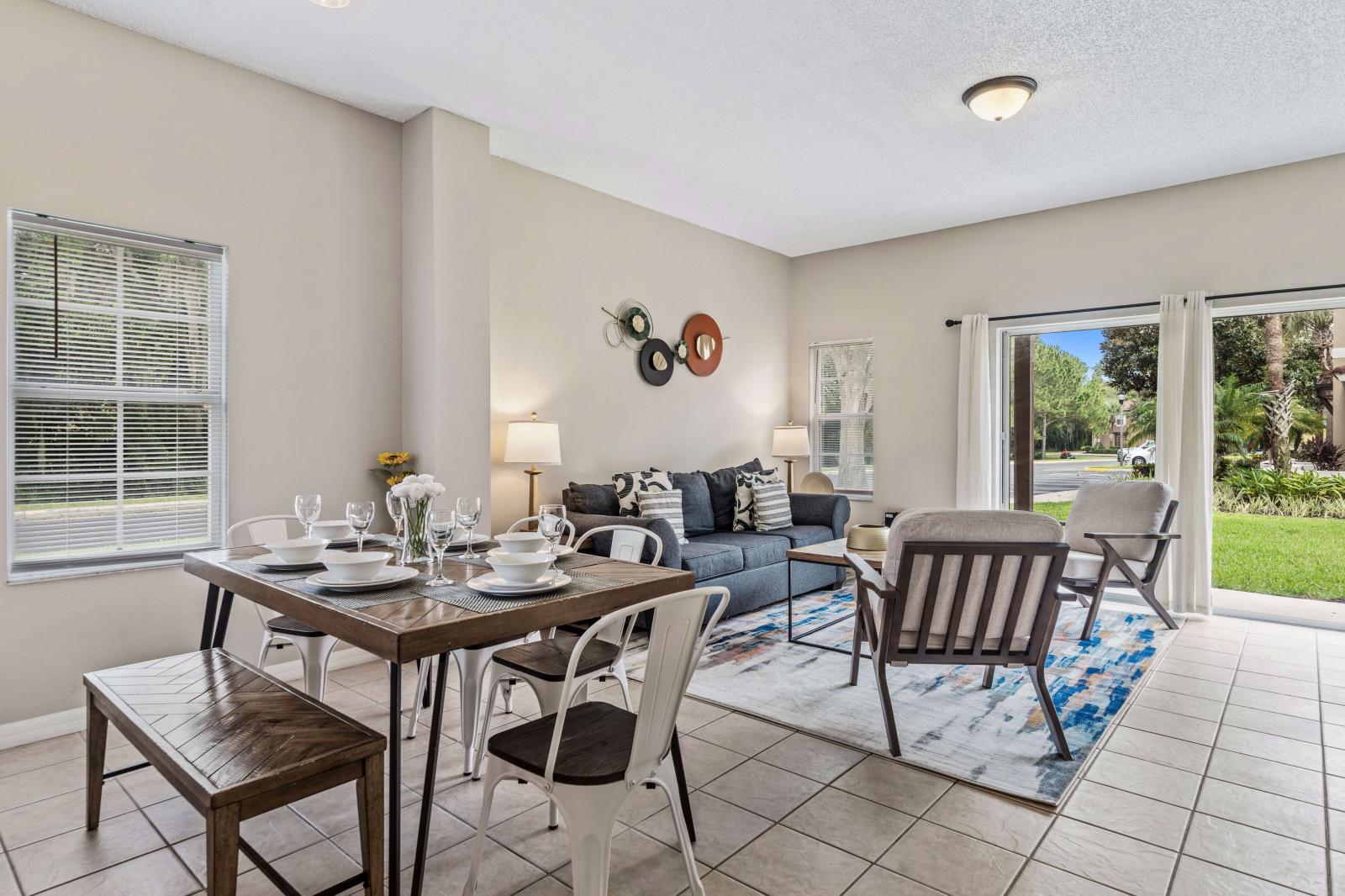 Dining area adjacent to the living, featuring a large wooden table with seating for 6 people - Ideal for family meals and gatherings, with metal chairs and a bench  - Open layout allows for easy interaction and flow between the living and dining