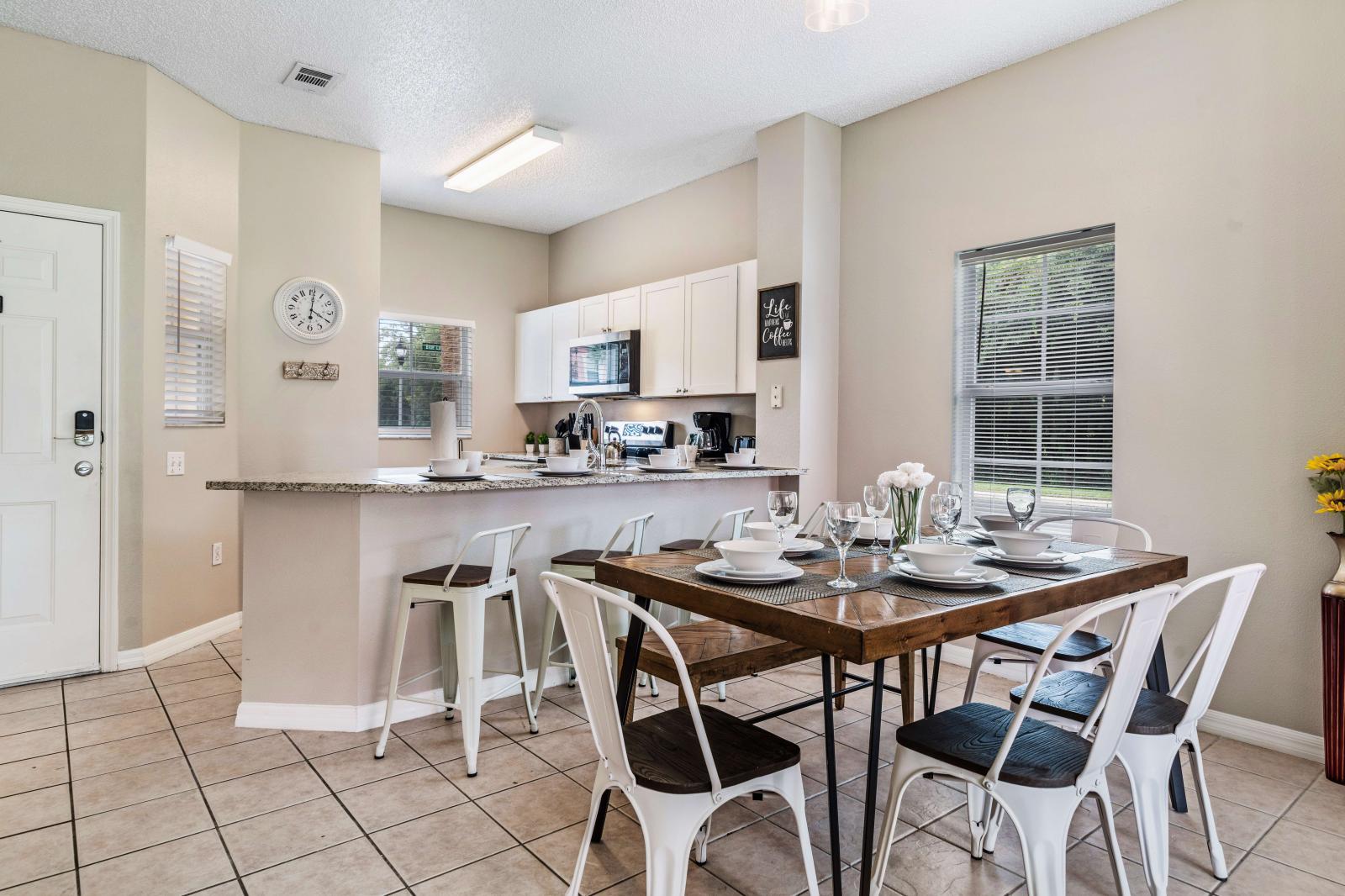 Fully equipped kitchen with modern appliances, including a stainless steel stove, microwave, and dishwasher - Granite countertops provide for meal preparation, and the breakfast bar with seating - Designed for both functionality and style