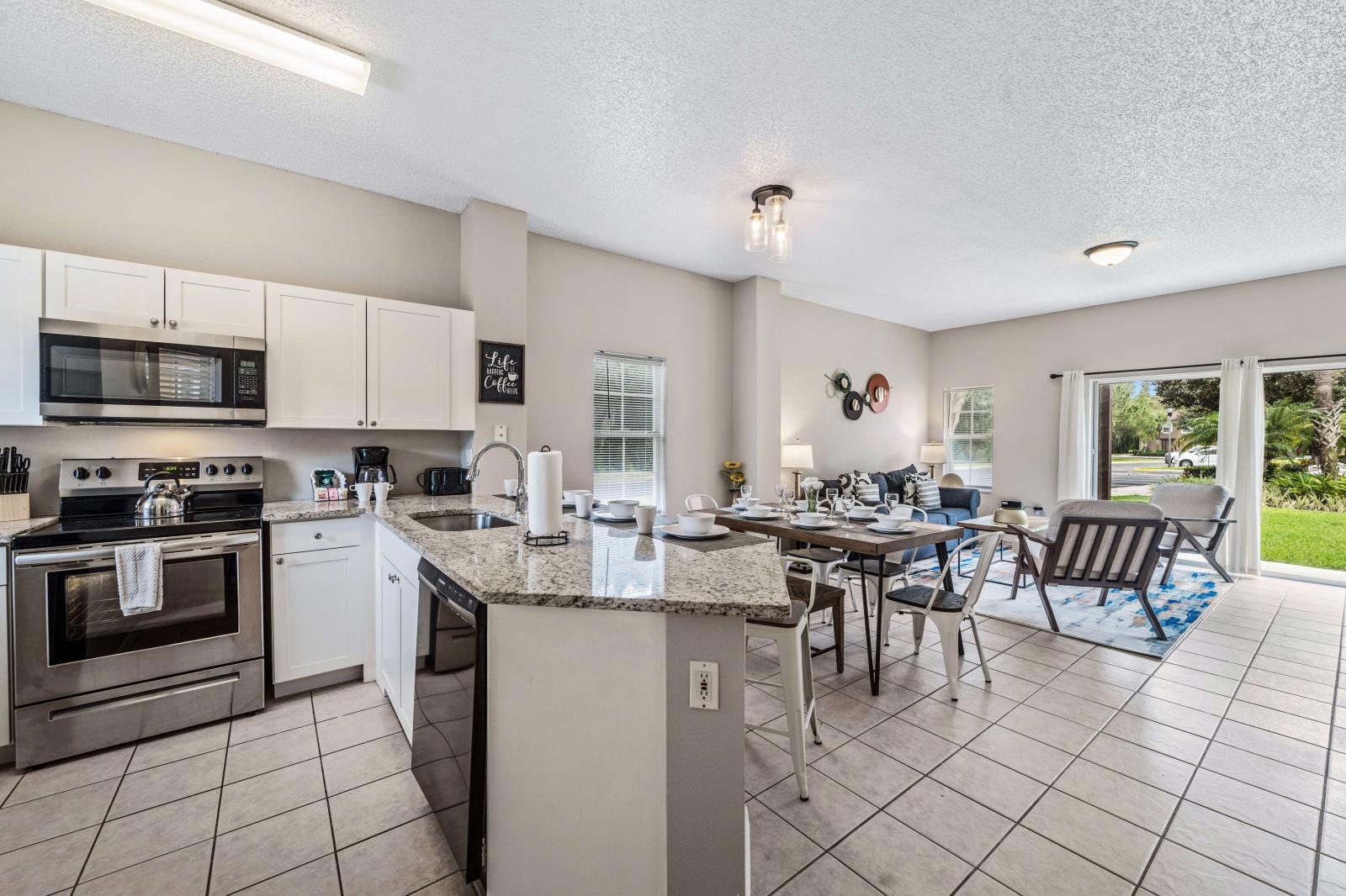 Modern kitchen area with plenty of storage, offering a clean and contemporary look - Includes essential amenities for cooking and dining in, such as a coffee maker, toaster - Perfect for preparing home-cooked meals and enjoying a comfortable stay