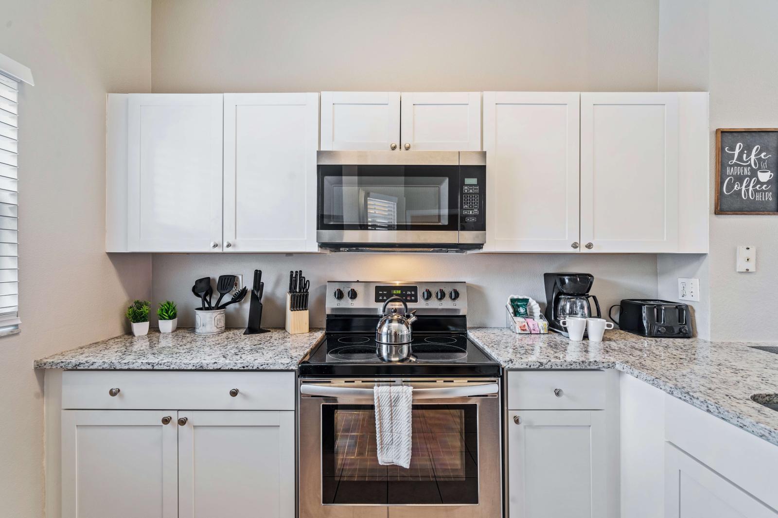 Step into this modern kitchen with essentials, perfect for all your cooking needs - Beautiful granite countertops paired with sleek cabinets, providing a clean and sophisticated look - Functional layout designed for efficient meal preparation