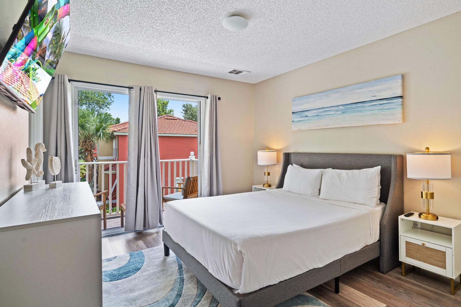 Experience tranquility in elegant bedroom with a plush queen-sized bed ensuring a peaceful sleep - Charming private balcony, perfect for outdoor enjoyment - Tasteful artwork and equipped with modern amenities, including a flat-screen TV