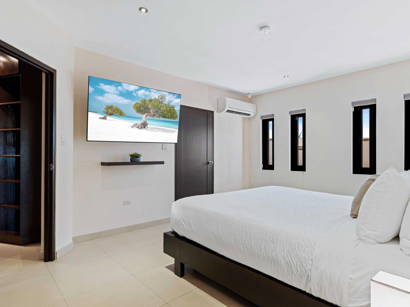 Bedroom 2 features a king size bed and a smart TV