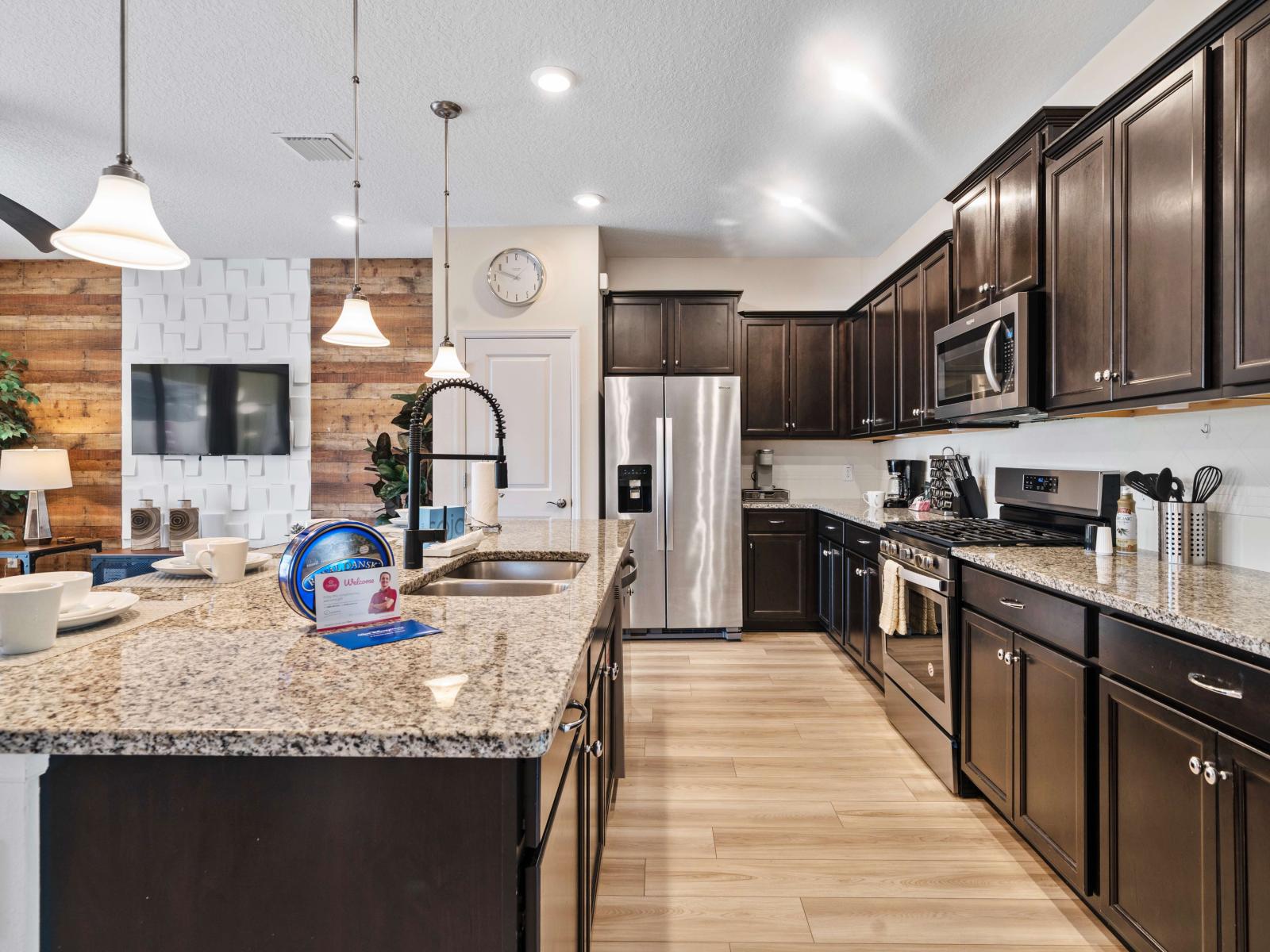 Modern kitchen with granite countertops, stainless steel appliances, and plenty of cabinet space - Open layout seamlessly connects to the living area with contemporary design - Spacious island, offering extra seating and a central gathering spot