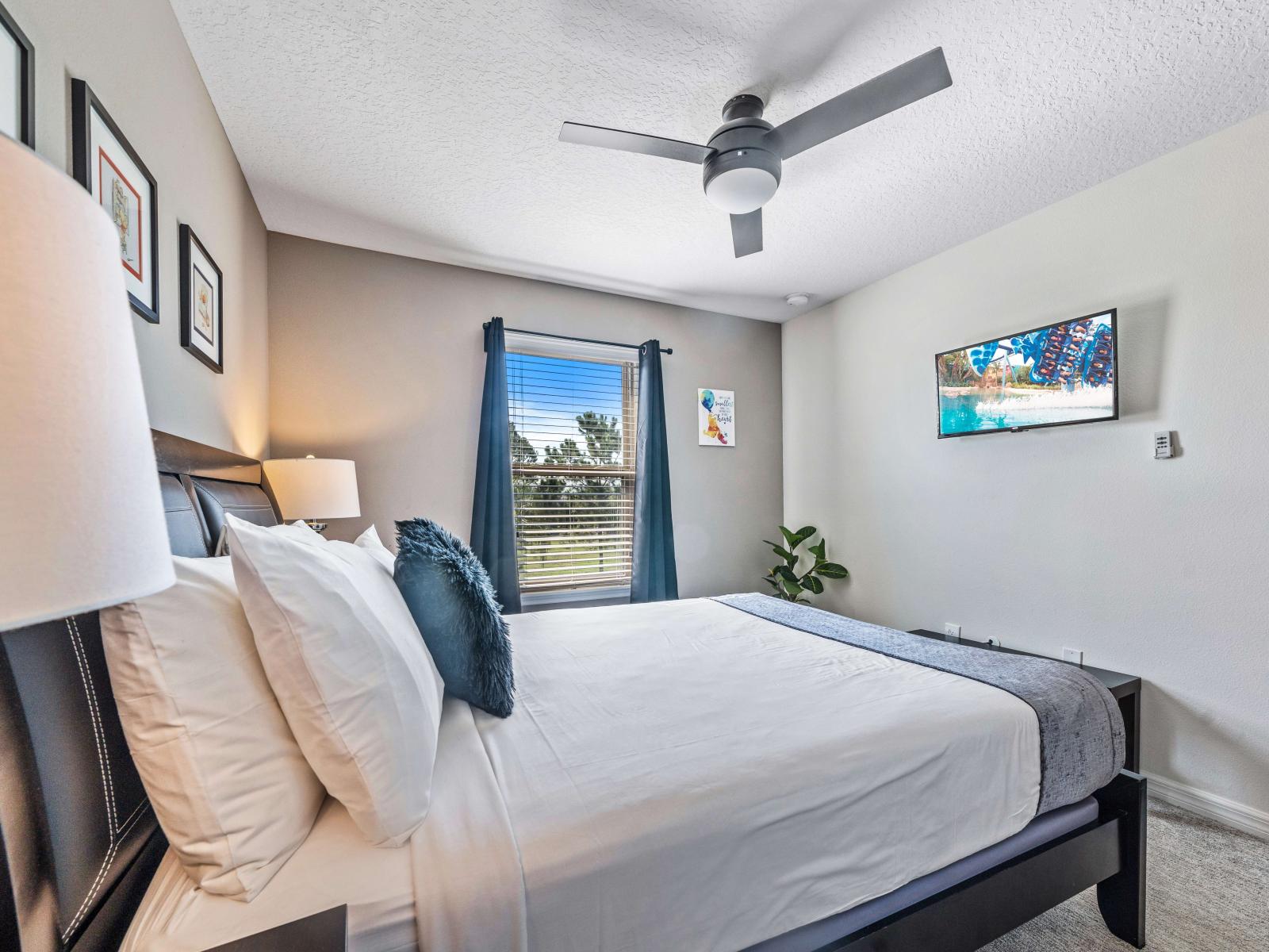 Bedroom features a plush queen-size bed perfect for your ultimate comfort - Enjoy your favorite shows on the smart TV from the comfort of your bed -  A serene space for a restful night's sleep