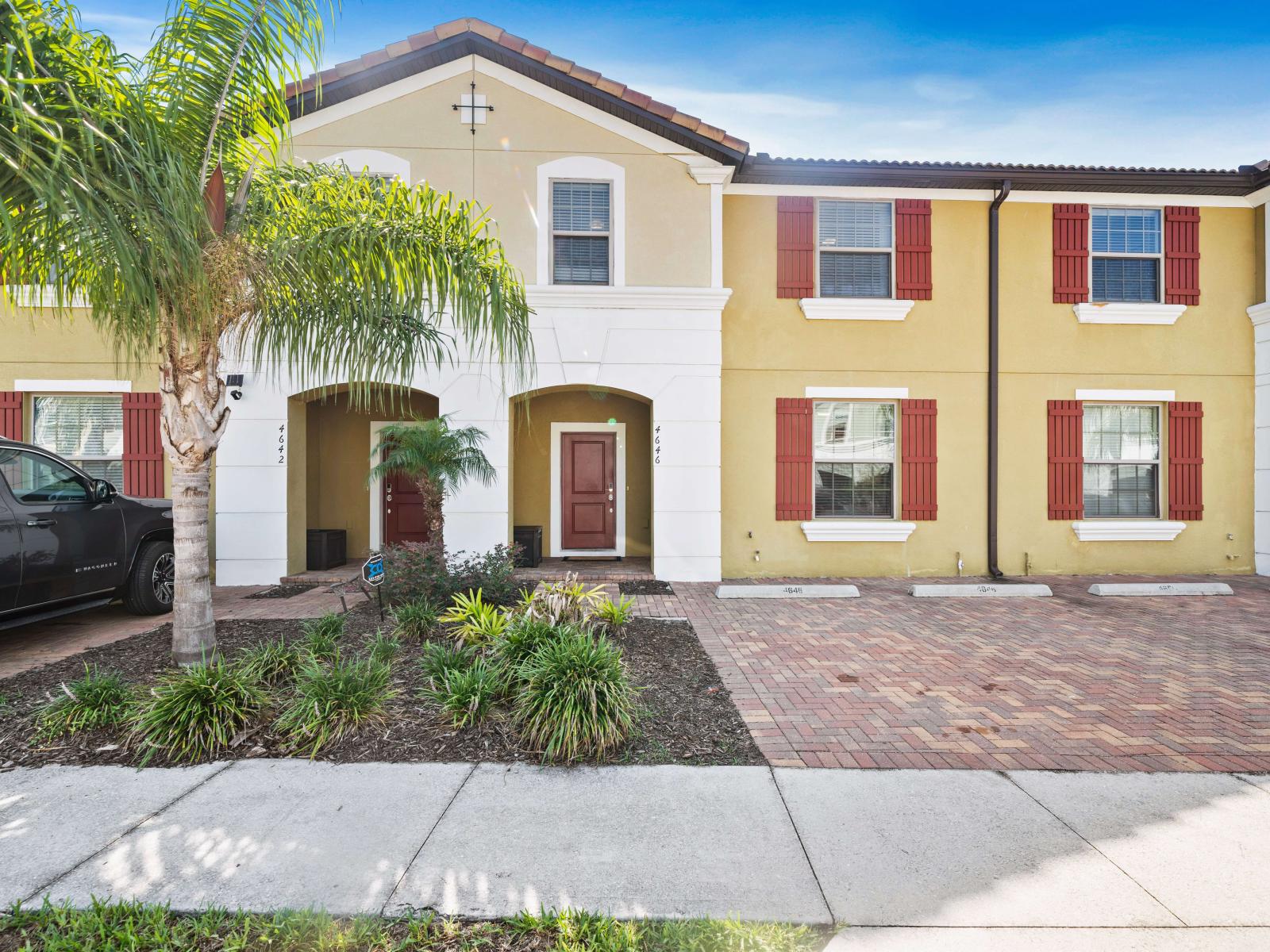 This charming townhouse, surrounded by well-maintained landscaping and a spacious brick driveway, providing a cozy and inviting home atmosphere.